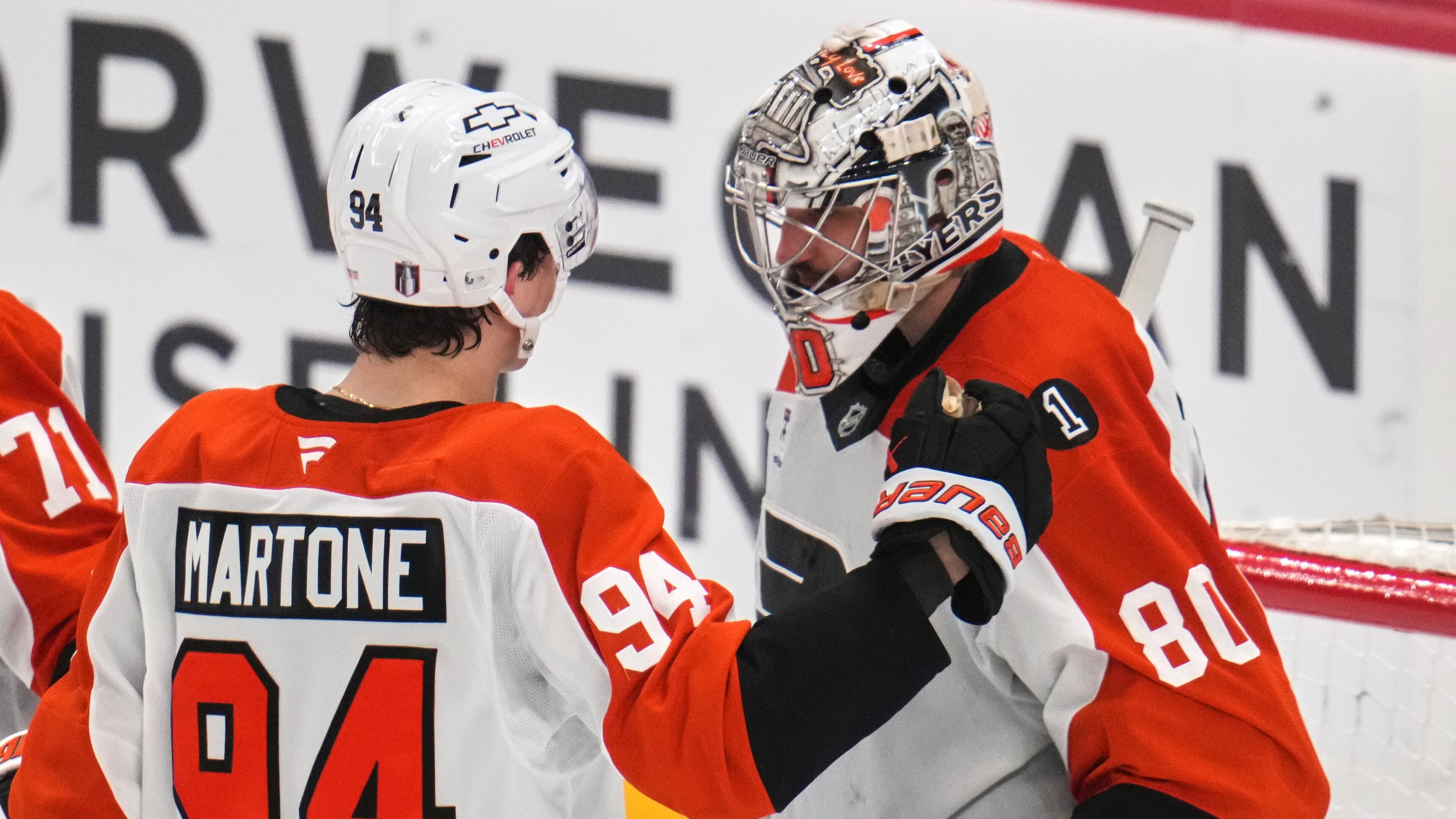 Philadelphia Flyers goaltender Dan Vladar (80) celebrates with Porter Martone (94) after time ran out in Game 2 in the first round of the NHL Stanley Cup playoffs against the Pittsburgh Penguins in Pittsburgh, Monday, April 20, 2026. (AP Photo/Gene J. Puskar)