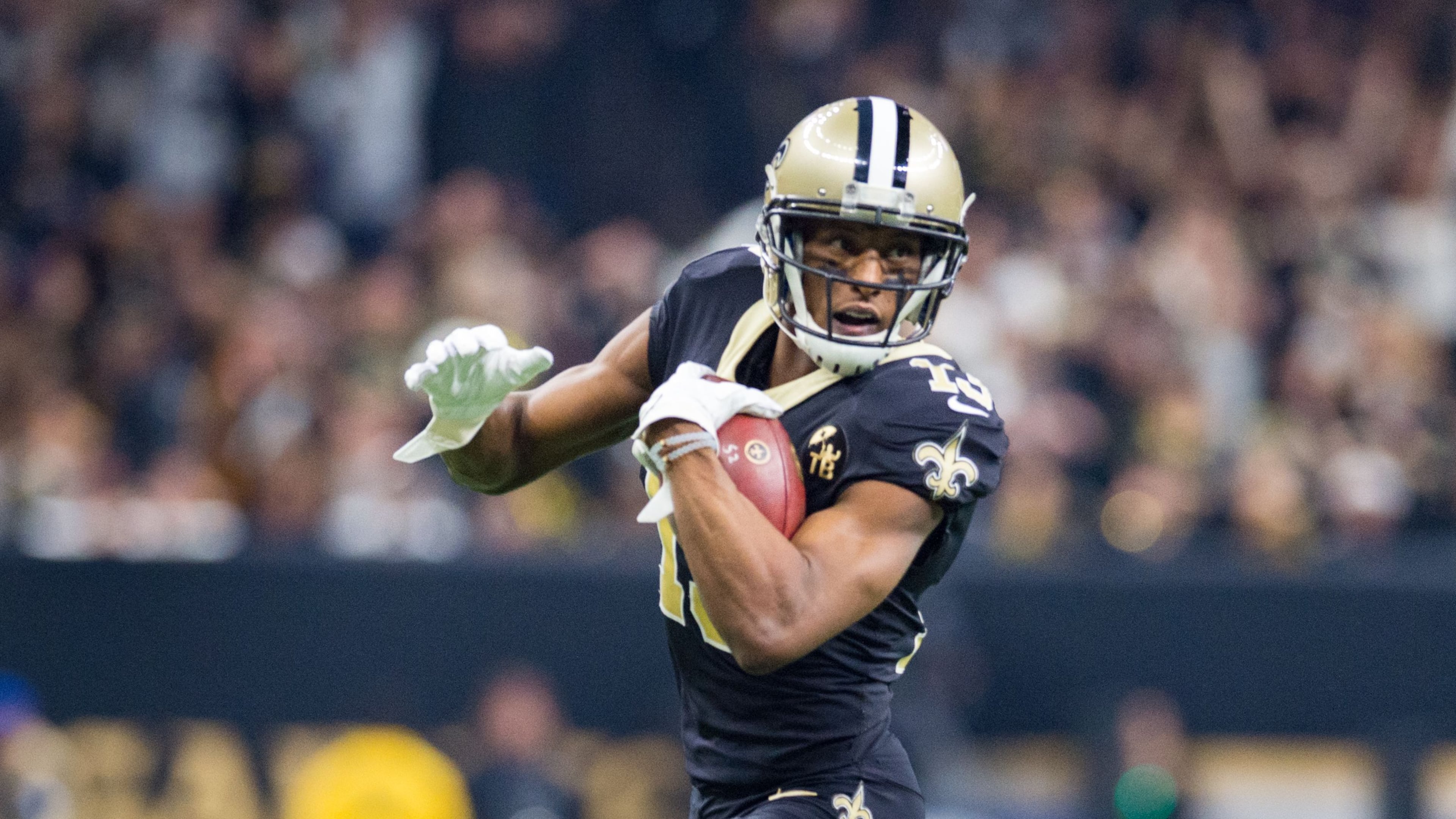 Michael Thomas of the Saints runs the ball during the NFC Championship Game against the Rams.