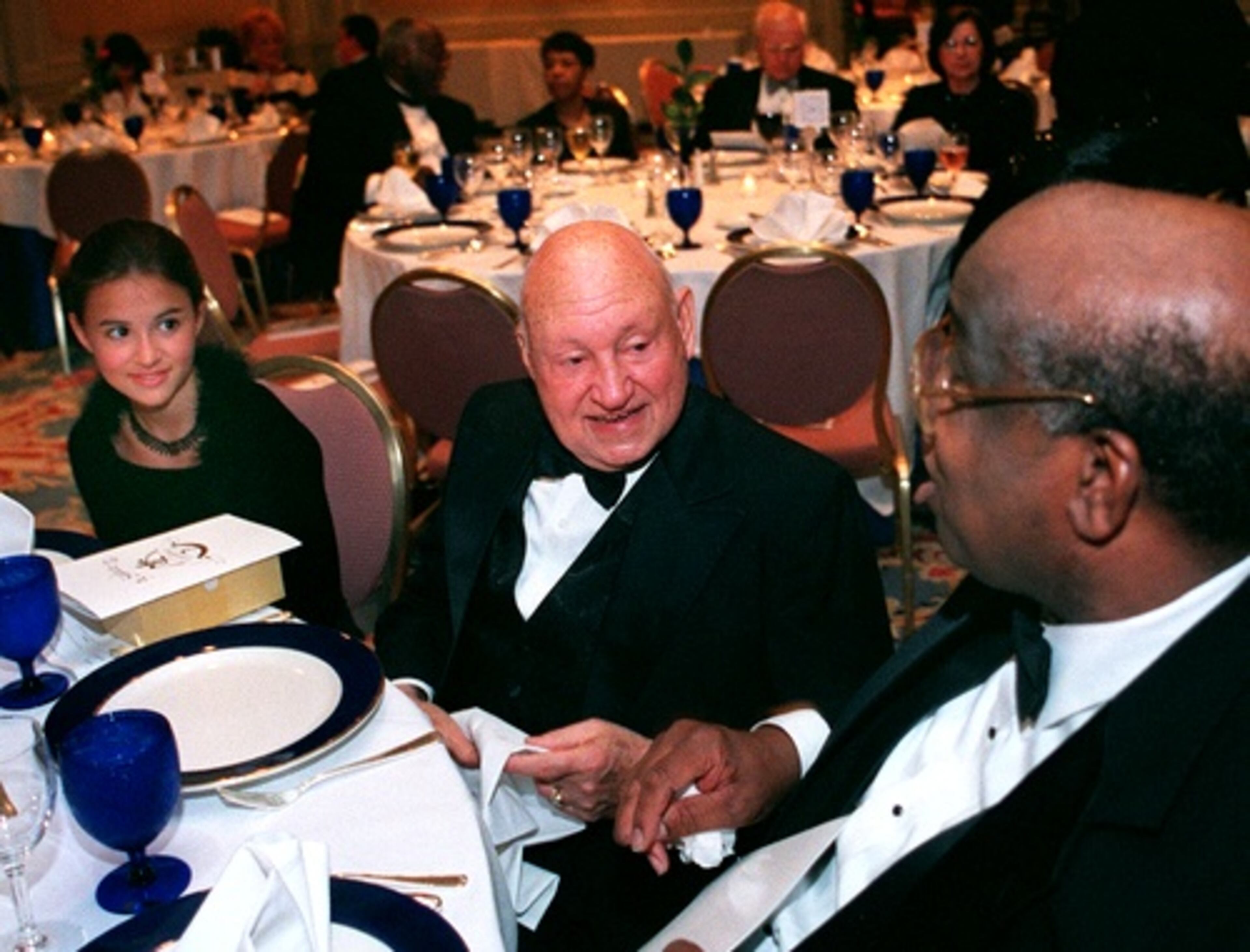 Cathy talks with Eddie White as Cathy's granddaughter Rachel Cathy, 14, listens during the 2001 Friends of Morehouse School of Medicine dinner. Cathy was one of the guests honored.