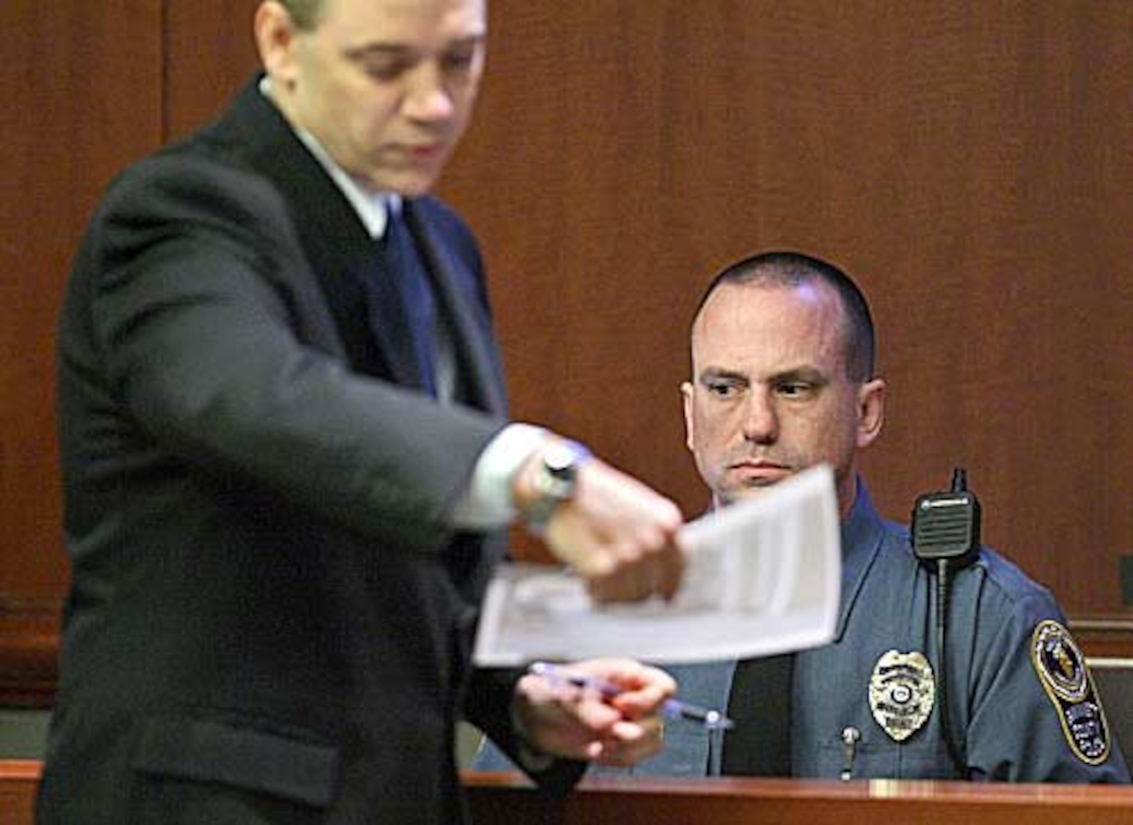 Gwinnett police officer Jason Teague testifies Tuesday as Assistant District Attorney Brett Pinion questions him about events in the Brian Nichols trial.