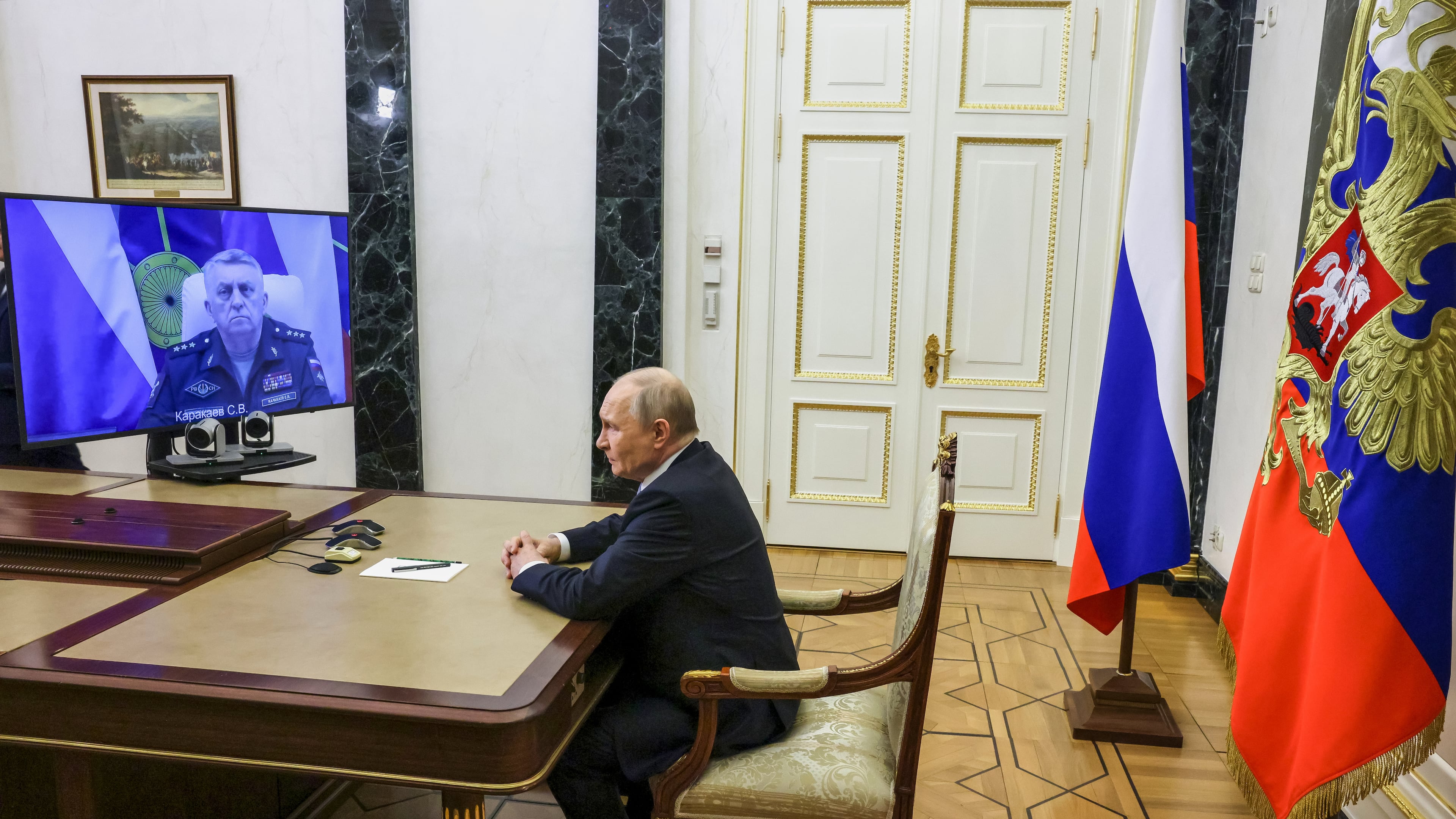 Russian Strategic Missile Forces chief, Col. Gen. Sergei Karakayev, left on the screen, reports to President Vladimir Putin on a successful test launch of the Sarmat intercontinental ballistic missile at the Kremlin in Moscow, Tuesday, May 12, 2026. (Mikhail Metzel/Sputnik, Kremlin Pool Photo via AP)