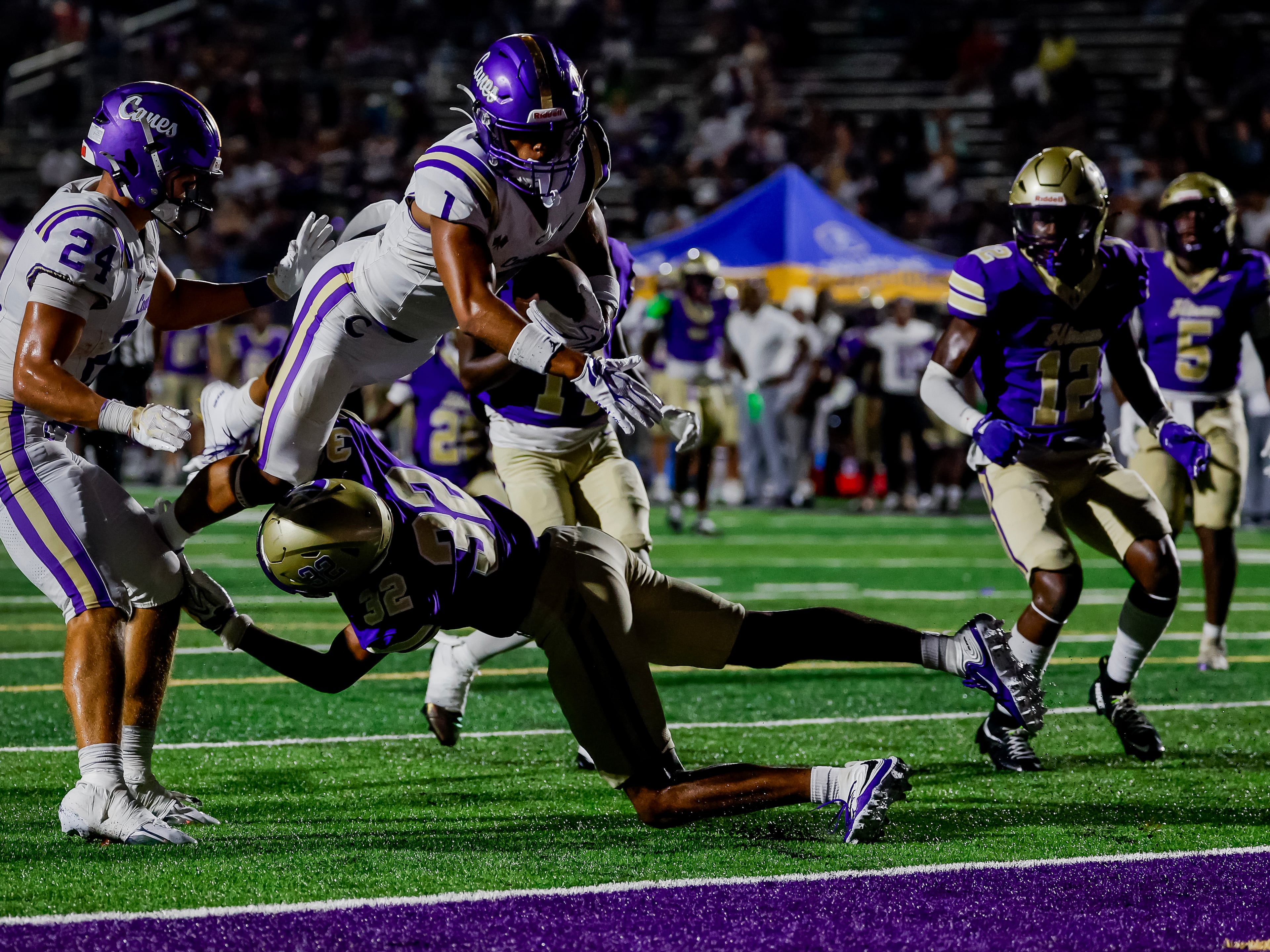 Cartersville wide receiver Madoxx Davis dives over Hiram safety Dorian Robinson for a touchdown on Friday, Aug. 21, 2026, in Hiram. (Erik S. Lesser for the AJC)