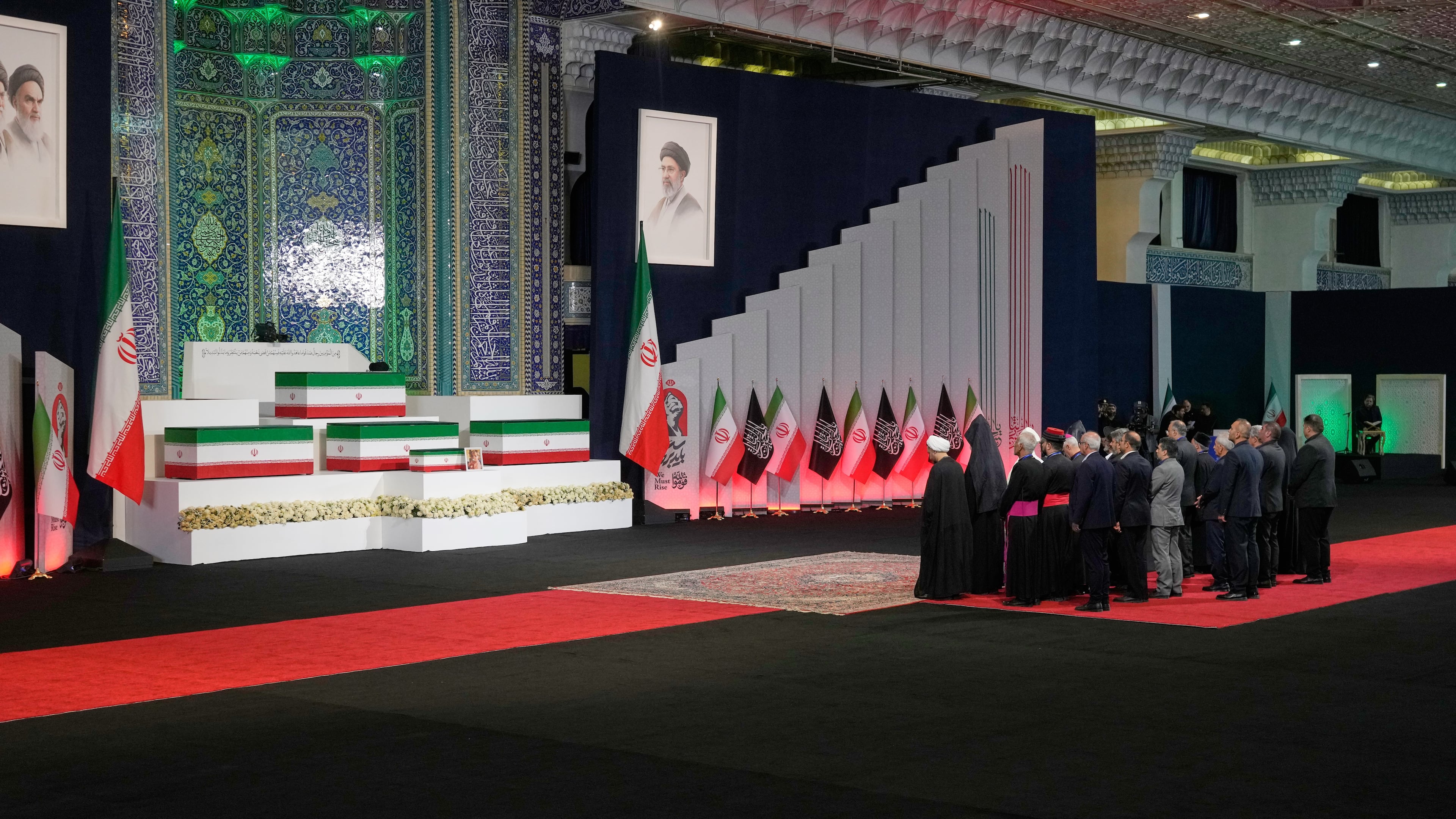 Iranian religious leaders and other mourners pay their respects before the coffins of slain Iranian Supreme Leader Ayatollah Ali Khamenei and members of his family during a viewing ceremony ahead of the dayslong funeral ceremonies at the Imam Khomeini Mosalla Grand Mosque in Tehran, Iran, Friday, July 3, 2026. (AP Photo/Vahid Salemi)