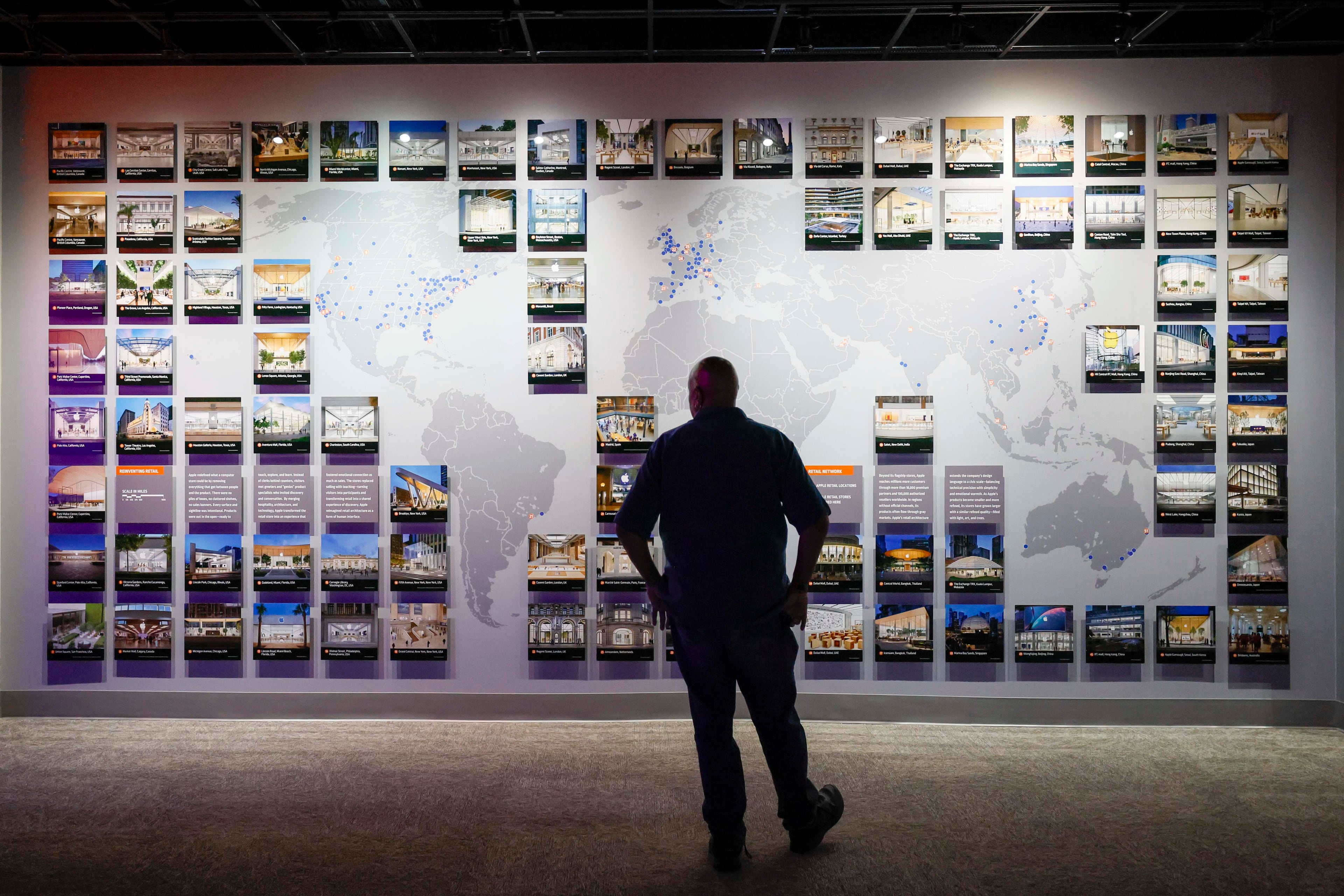 A visitor looks at a map displaying the locations of Apple stores worldwide at the "50 Years of Innovation from Apple" exhibit at the Mimms Museum in Roswell on Sunday, April 19, 2026.
(Miguel Martinez/AJC)