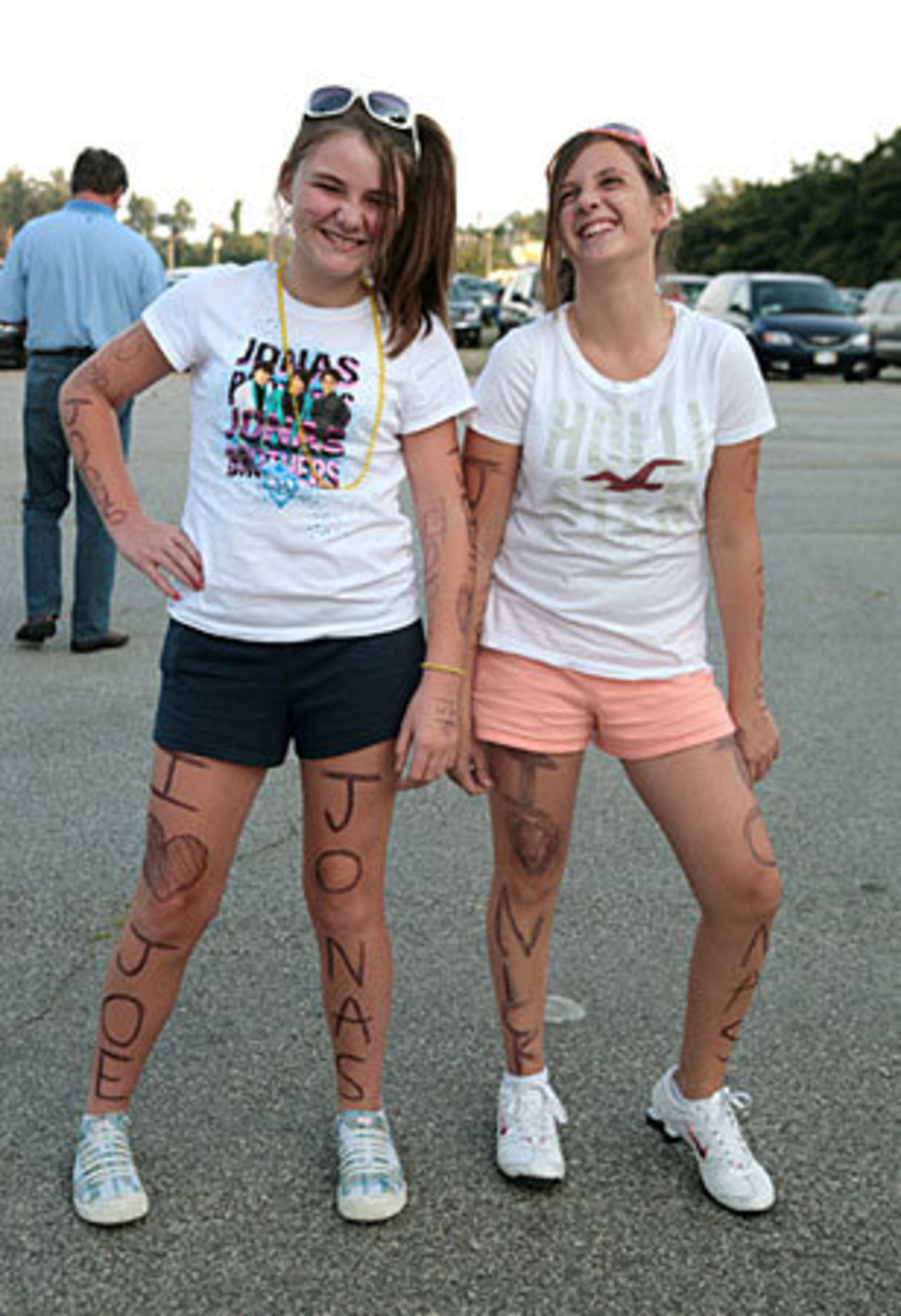 Taylor McMillian, 12, (left) and Morgan McGill of Soddydaisy, Tenn., show their love of the Jonas Brothers with fashion and temporary hand-drawn tattoos.