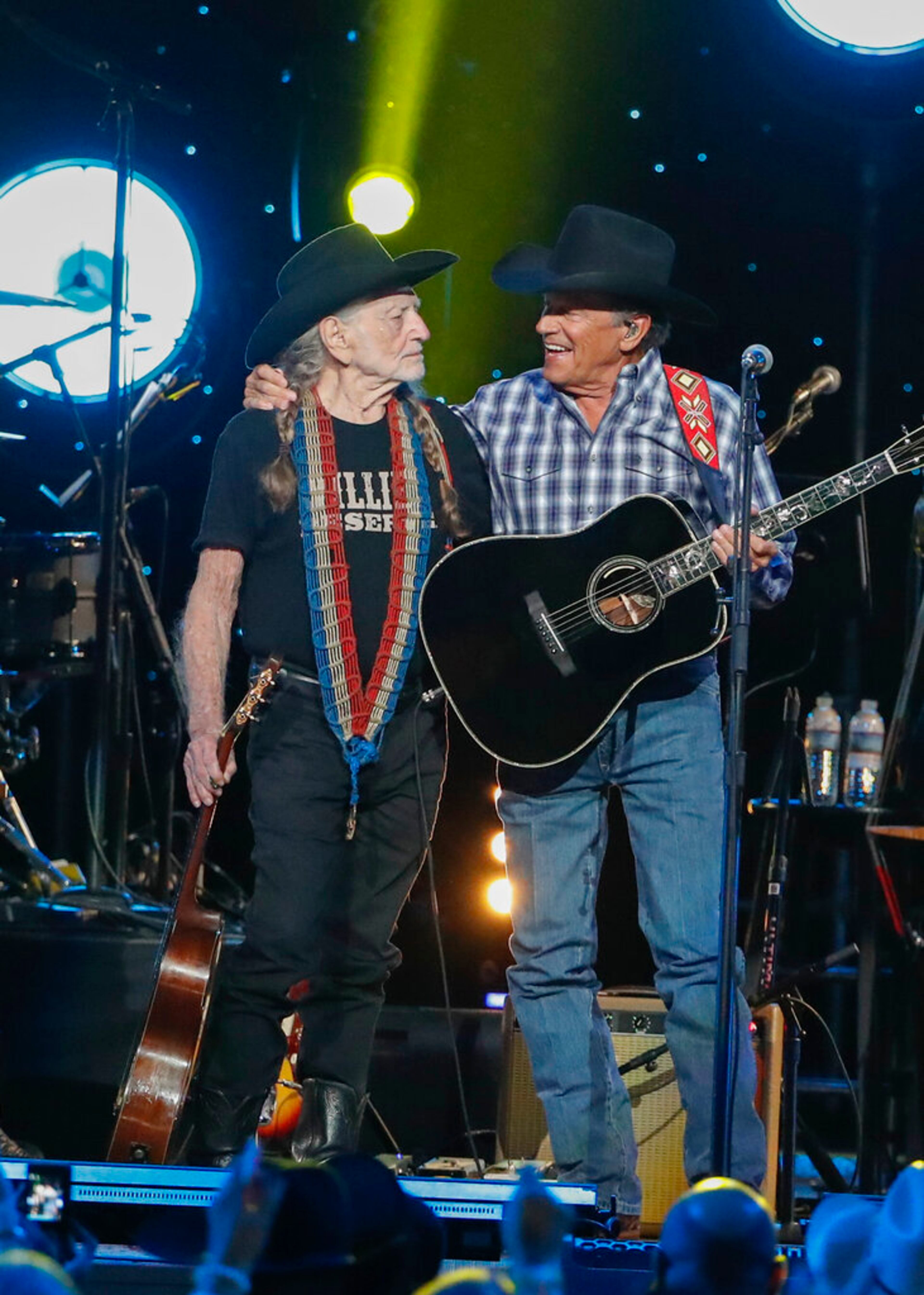 Willie Nelson, left, and George Strait perform at Willie: Life & Songs Of An American Outlaw at Bridgestone Arena on Saturday, Jan. 12, 2019, in Nashville, Tenn. (Photo by Al Wagner/Invision/AP)