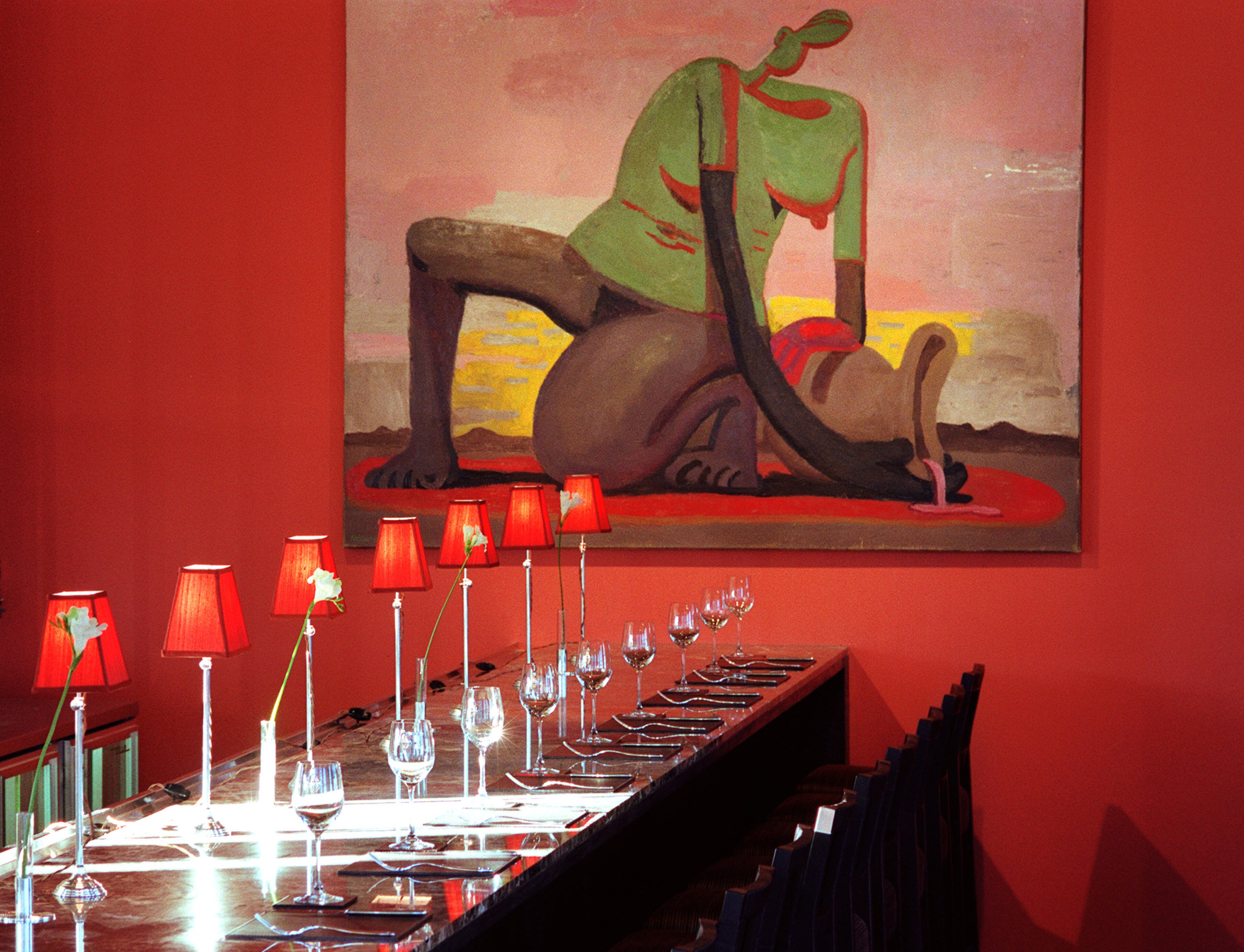 In 2000, Bacchanalia features modern art & classic appointments such as a marble bar and shaded lamps.