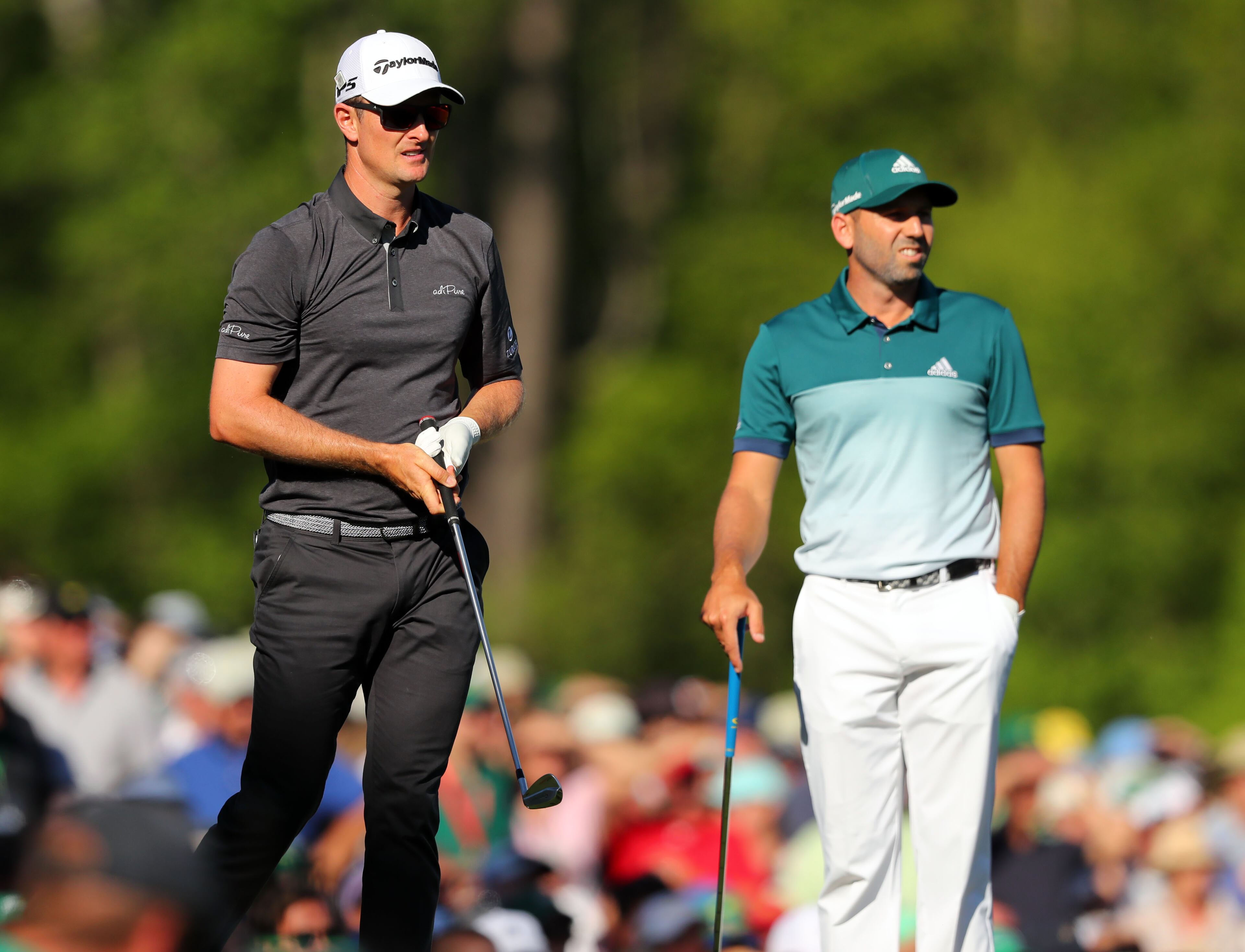Justin Rose (left) and Sergio Garcia watch Rose's tee shot from the 12th tee.