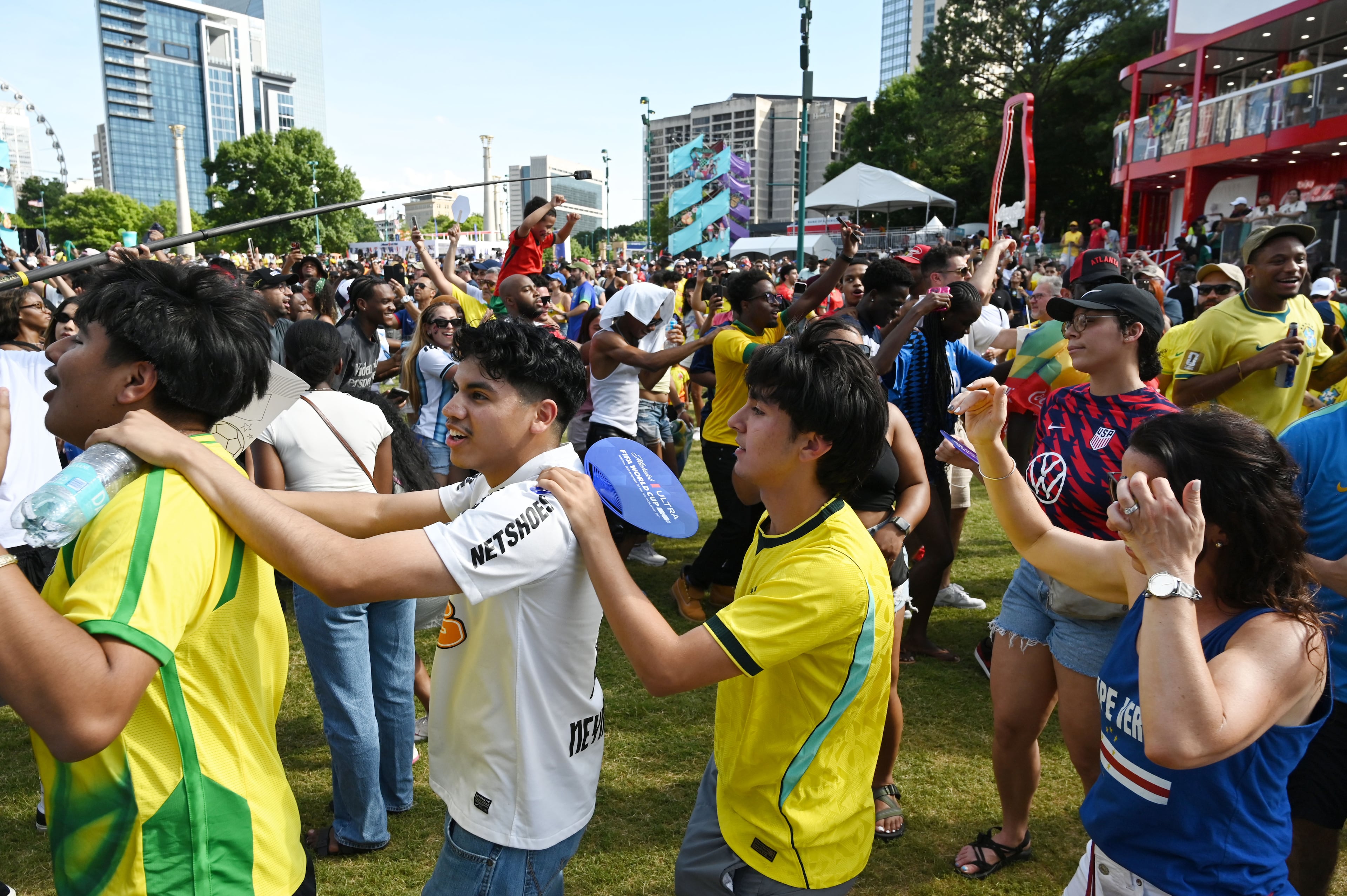 Brazil soccer fans mingle and dance while gathering for a watch party ahead of the match between Brazil and Morocco at the FIFA Fan Festival. (Hyosub Shin/AJC)