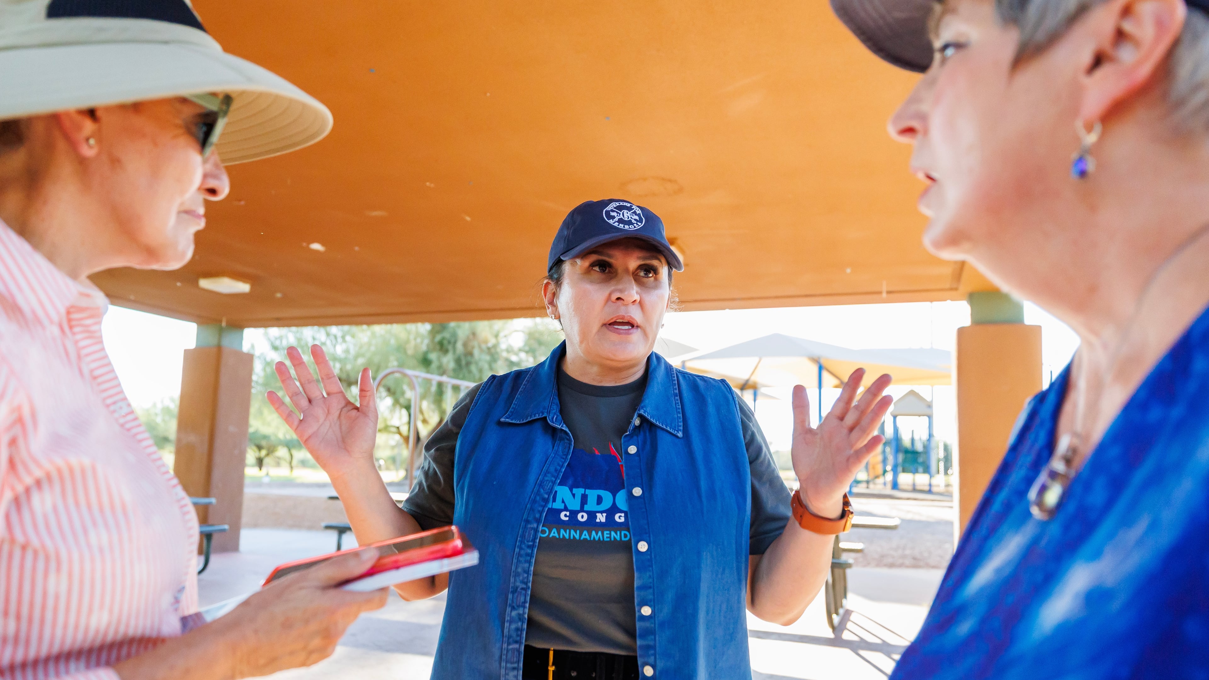 JoAnna Mendoza (D), an Arizona Congressional District 6 candidate, center, talks with campaign volunteers before a weekly neighborhood canvass, Thursday, Oct. 15, 2026, in Oro Valley, Ariz. (AP Photo/Mike Christy)