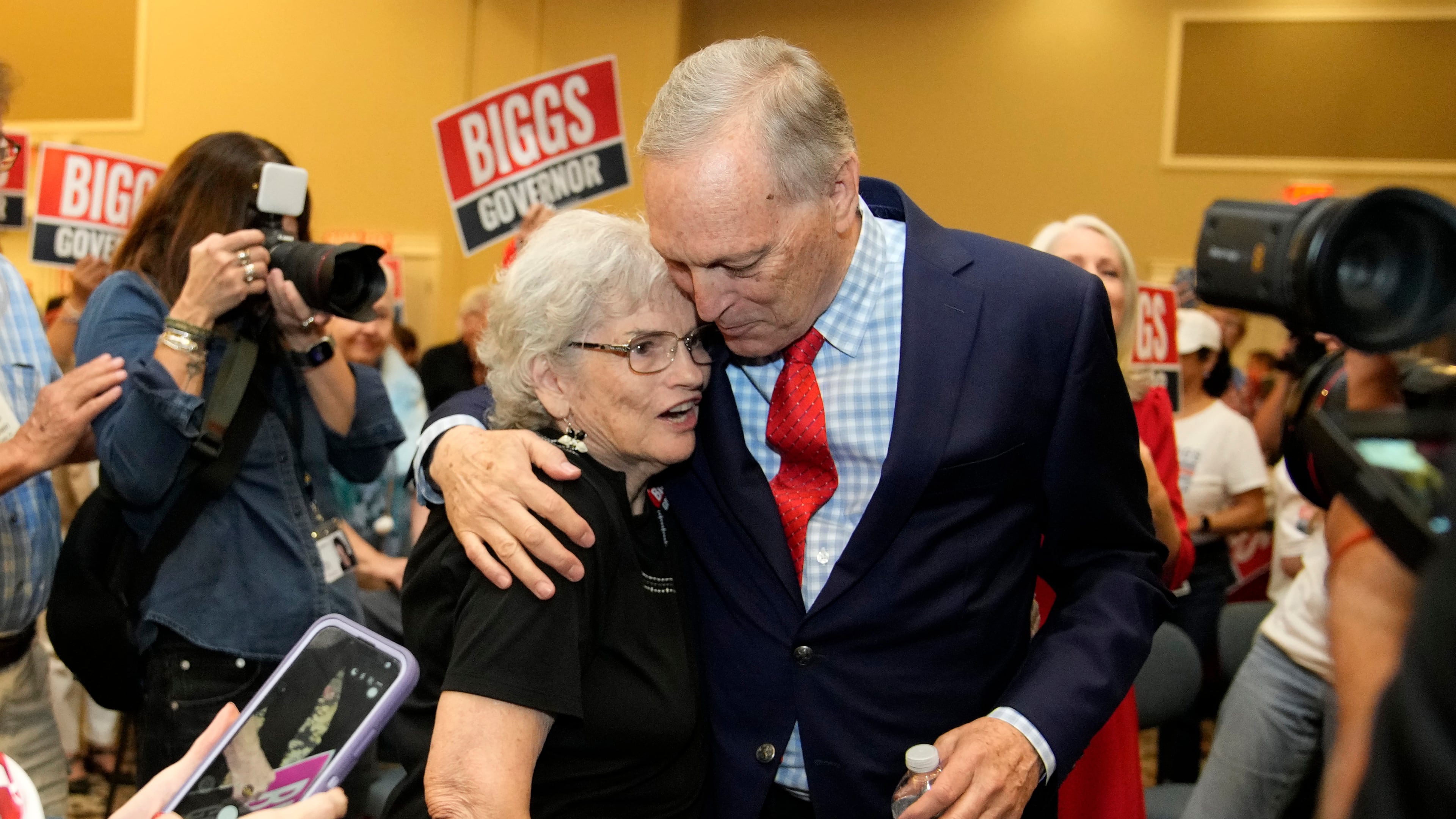 Rep. Andy Biggs, right, R-Ariz., who is running in the primary for Arizona governor, hugs a supporter at a campaign event, Friday, July 17, 2026, in Gilbert, Ariz. (AP Photo/Ross D. Franklin)