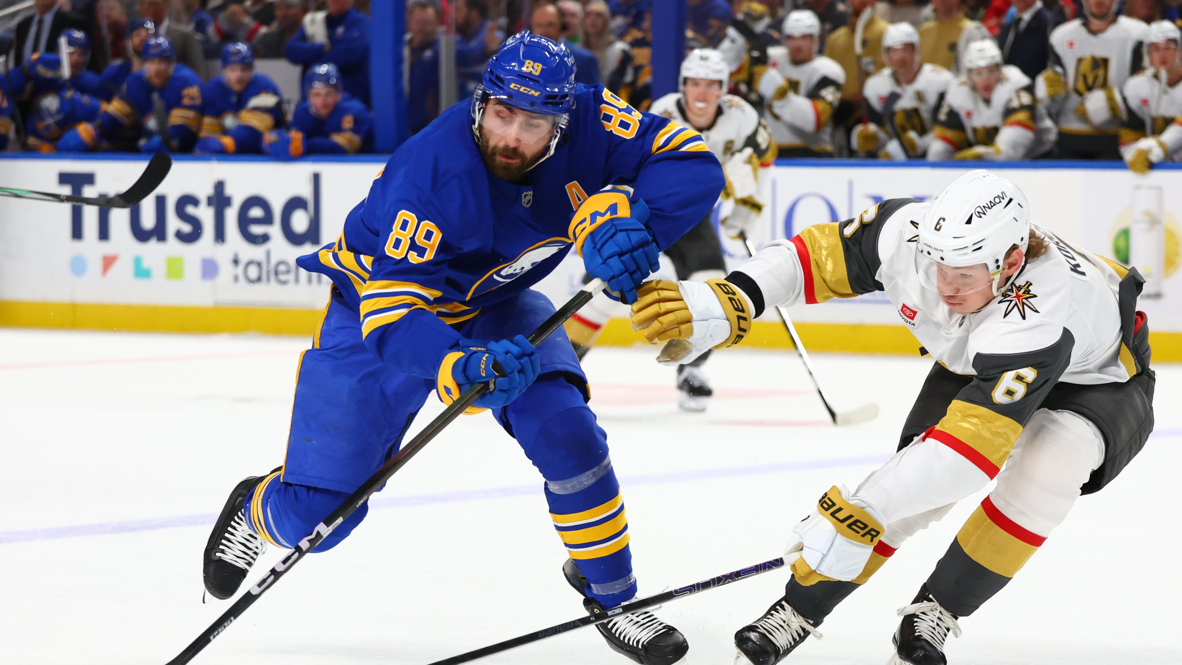 FILE - Buffalo Sabres right wing Alex Tuch (89) is stick checked by Vegas Golden Knights defenseman Kaedan Korczak (6) during the first period of an NHL hockey game, March 3, 2026, in Buffalo, N.Y. (AP Photo/Jeffrey T. Barnes, File)