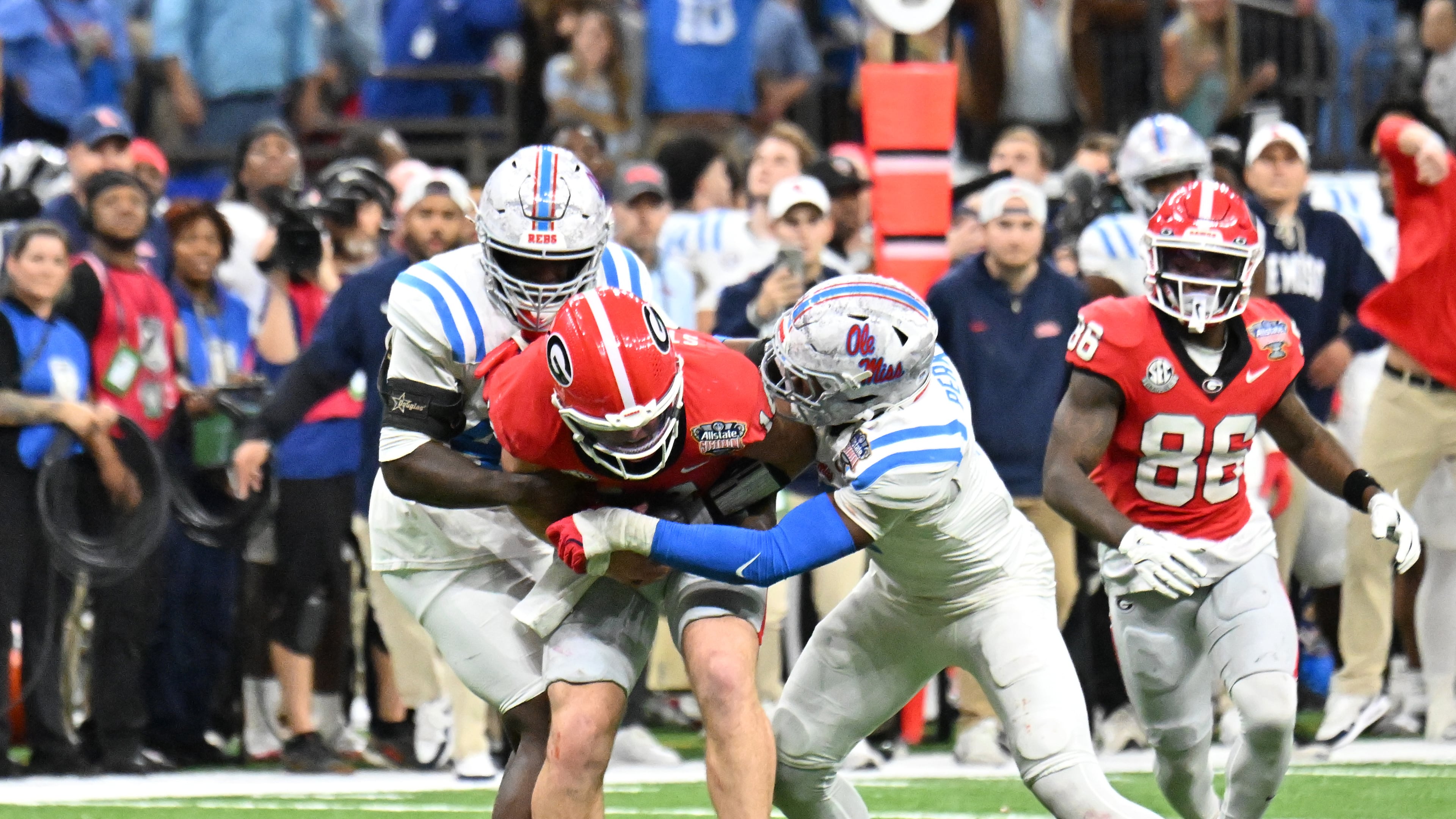 One former NFL scout said of Georgia quarterback Gunner Stockton (center), pictured being tackled against Ole Miss in the Sugar Bowl College Football Playoff game in January: "He’s a talented kid and a great leader, but we have to see if the traits equate to the NFL.” (Hyosub Shin/AJC)