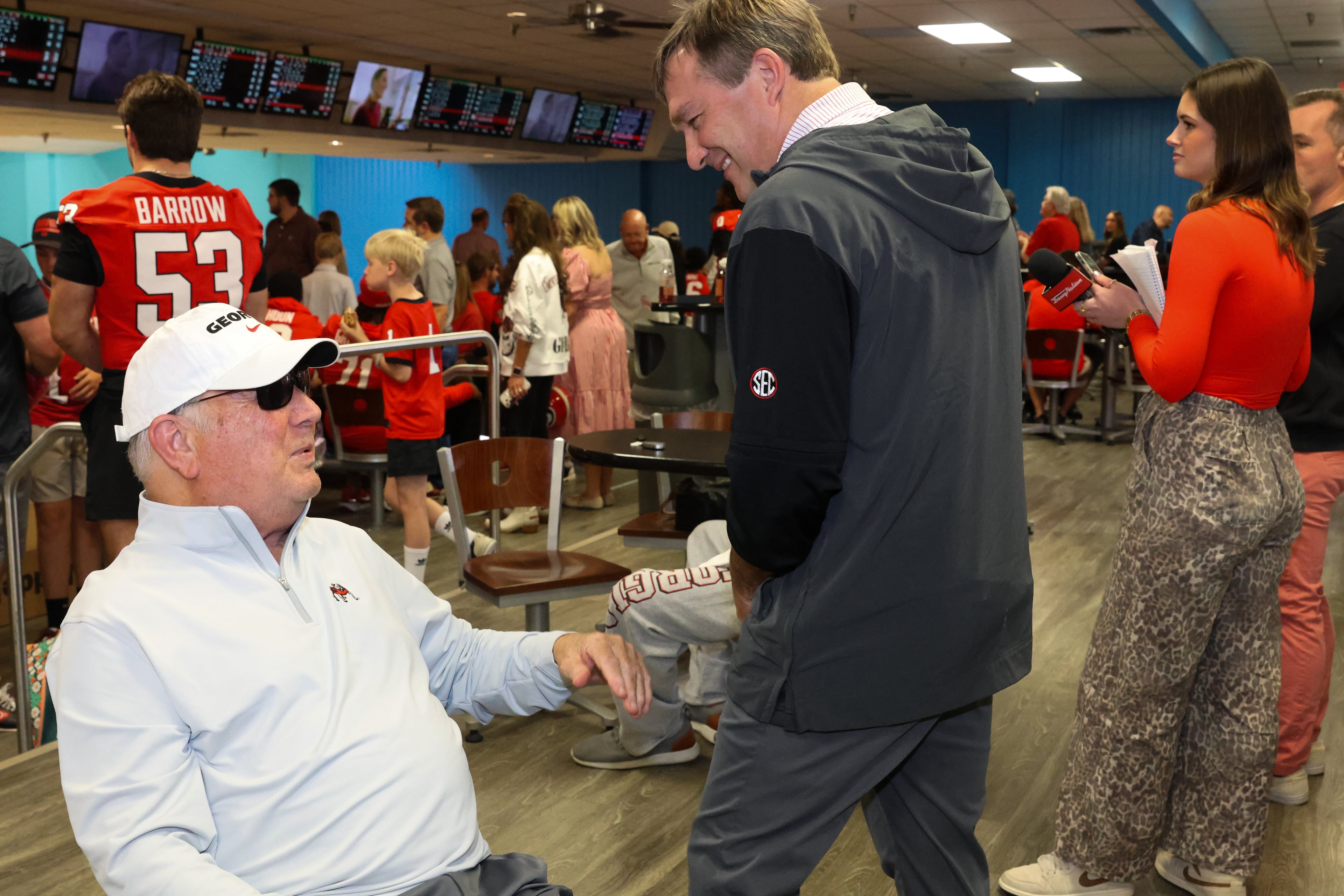 Former UGA football coach Jim Donnan (left) talks with current head coach Kirby Smart during the third annual Chick-fil-A Dawg Bowl fundraiser for Parkinson’s and Crohn’s disease research at Showtime Bowl in Athens on Wednesday, Oct. 22, 2025. Donnan coached the Bulldogs from 1996 to 2000. (C.J. Bartunek for the AJC)