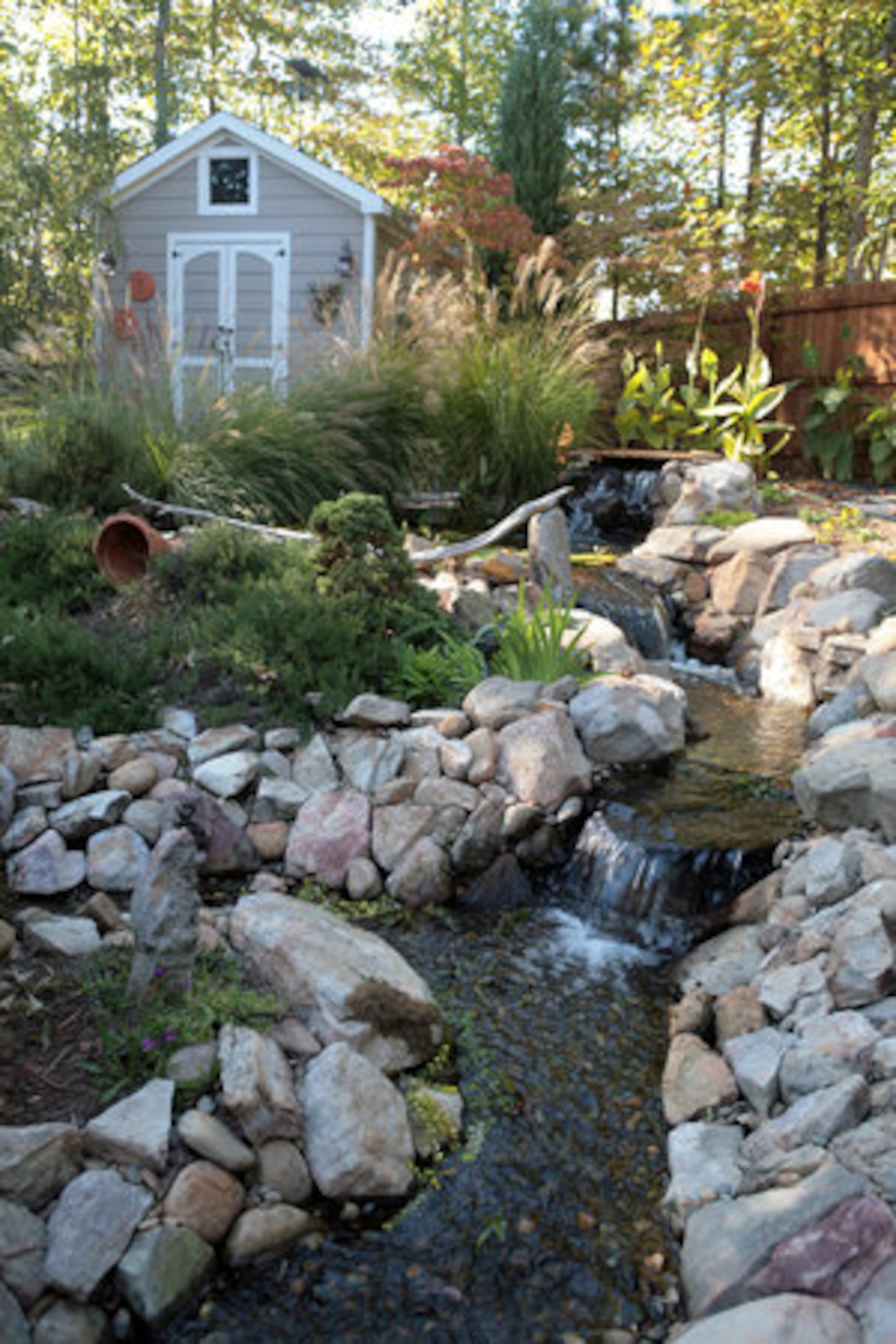 McCraw enjoyed a pond in her former Decatur home and recreated the water feature on a grander scale when she moved. A re-circulating water feature that flows from an upper pond downstream to a koi pond made use of the gently sloping land. Her garden was recently featured in the Coweta County Master Gardeners fall garden tour.