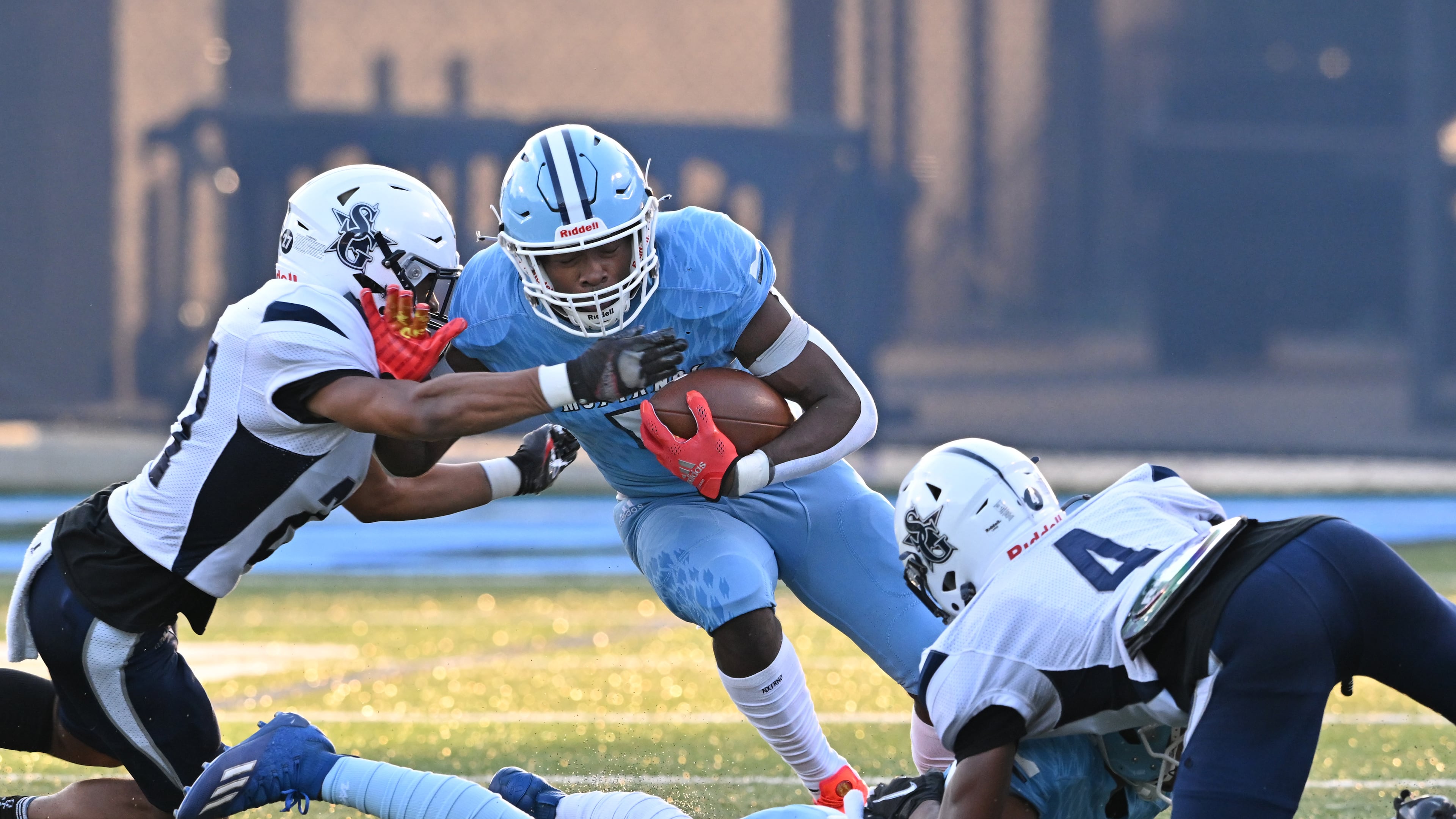 August 26 , 2022 Norcross - Meadowcreek's Jordan Louie (5) gets tackled by South Gwinnett's Daniel Hebbert (left) during the first half at Meadowcreek High School in Norcross on Friday, August 26, 2022. (Hyosub Shin / Hyosub.Shin@ajc.com)