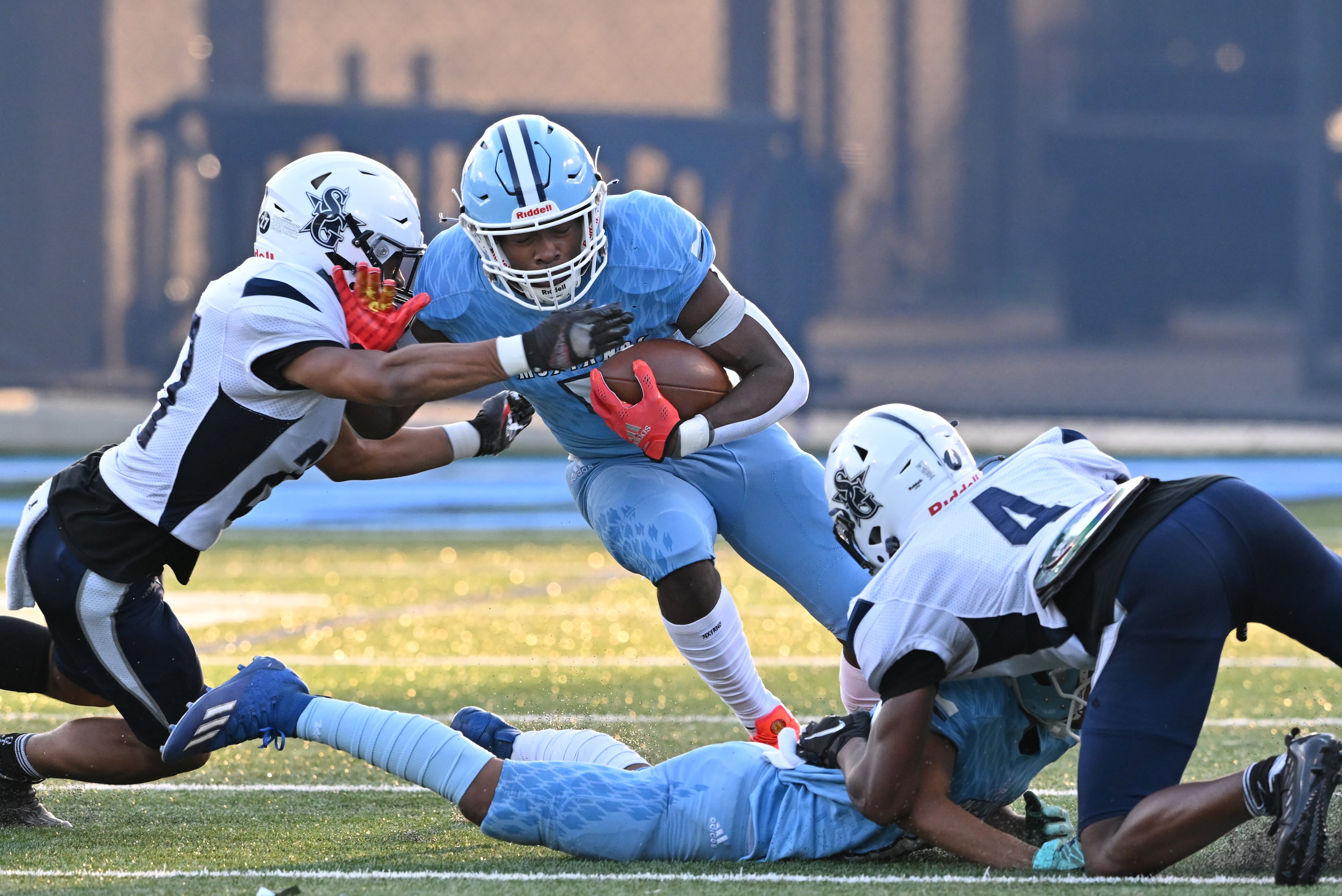 August 26 , 2022 Norcross - Meadowcreek's Jordan Louie (5) gets tackled by South Gwinnett's Daniel Hebbert (left) during the first half at Meadowcreek High School in Norcross on Friday, August 26, 2022. (Hyosub Shin / Hyosub.Shin@ajc.com)