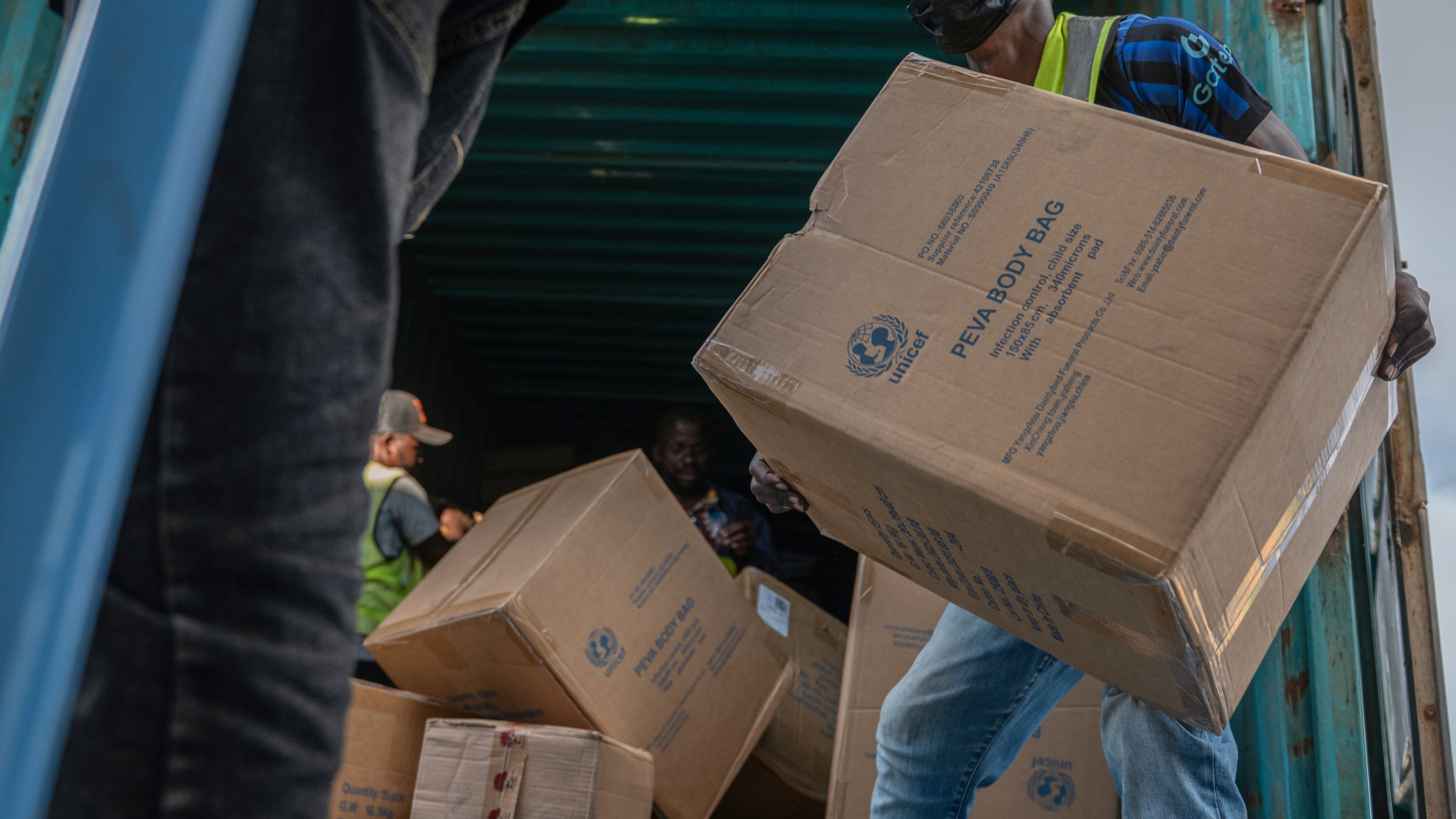 People offload a shipment of more than 15 tons of supplies donated by UNICEF as part of the response to the Ebola virus outbreak at Bunia National Airport in Bunia, Congo, Tuesday, May 19, 2026. (AP Photo/Moses Sawasawa)