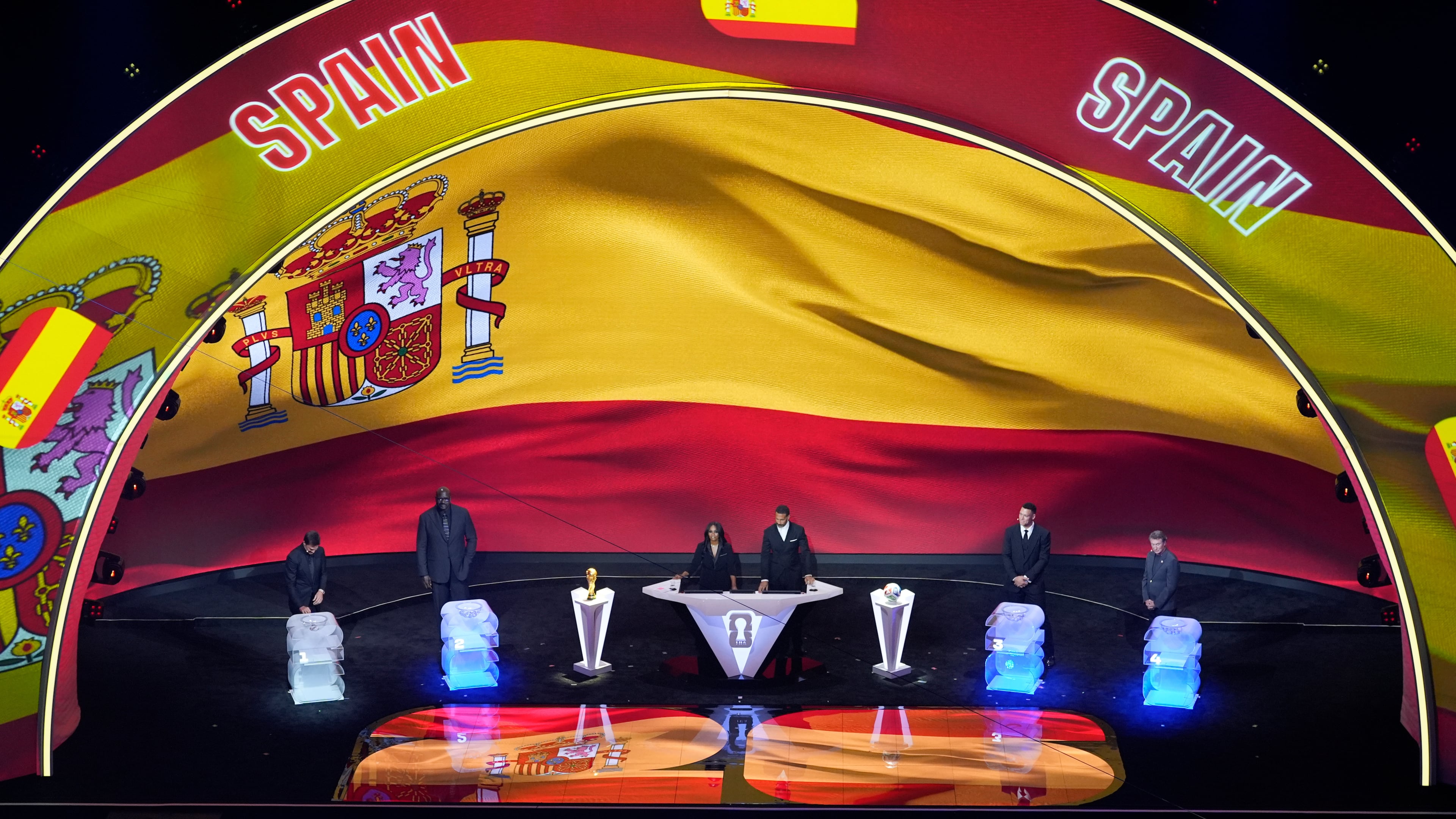 From left; former NFL player Tom Brady, former NBA player Shaquille O'Neal, broadcaster Samantha Johnson, former England soccer captain Rio Ferdinand, New York Yankees' Aaron Judge and former NHL player Wayne Gretzky participate in the draw for the 2026 soccer World Cup at the Kennedy Center in Washington, Friday, Dec. 5, 2025. (AP Photo/Alex Brandon)