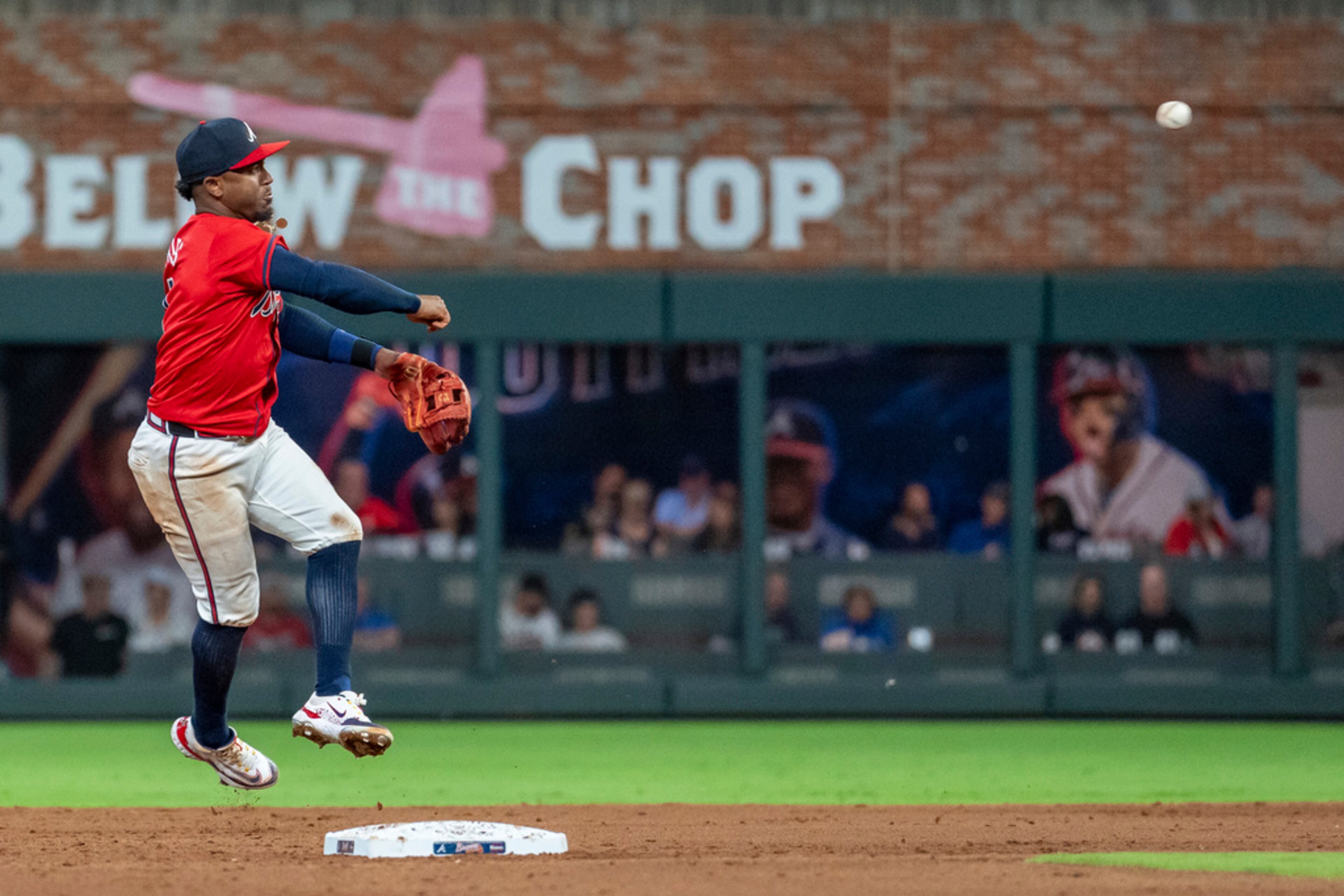 Atlanta Braves second baseman Ozzie Albies throws out Kansas City Royals' Kyle Isbel at first base in the sixth inning of a baseball game, Friday, Sept. 27, 2024, in Atlanta. (AP Photo/Jason Allen)