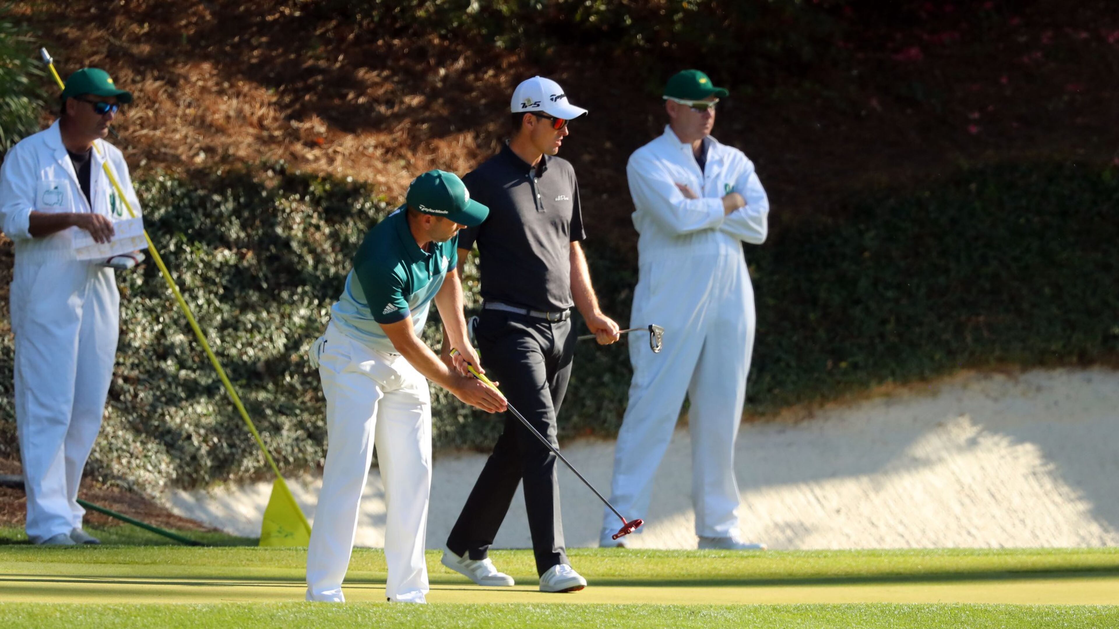 Sergio Garcia misses his birdie putt on the 12th green as Justin Rose walks by to line up his birdie attempt. CURTIS COMPTON/ AJC