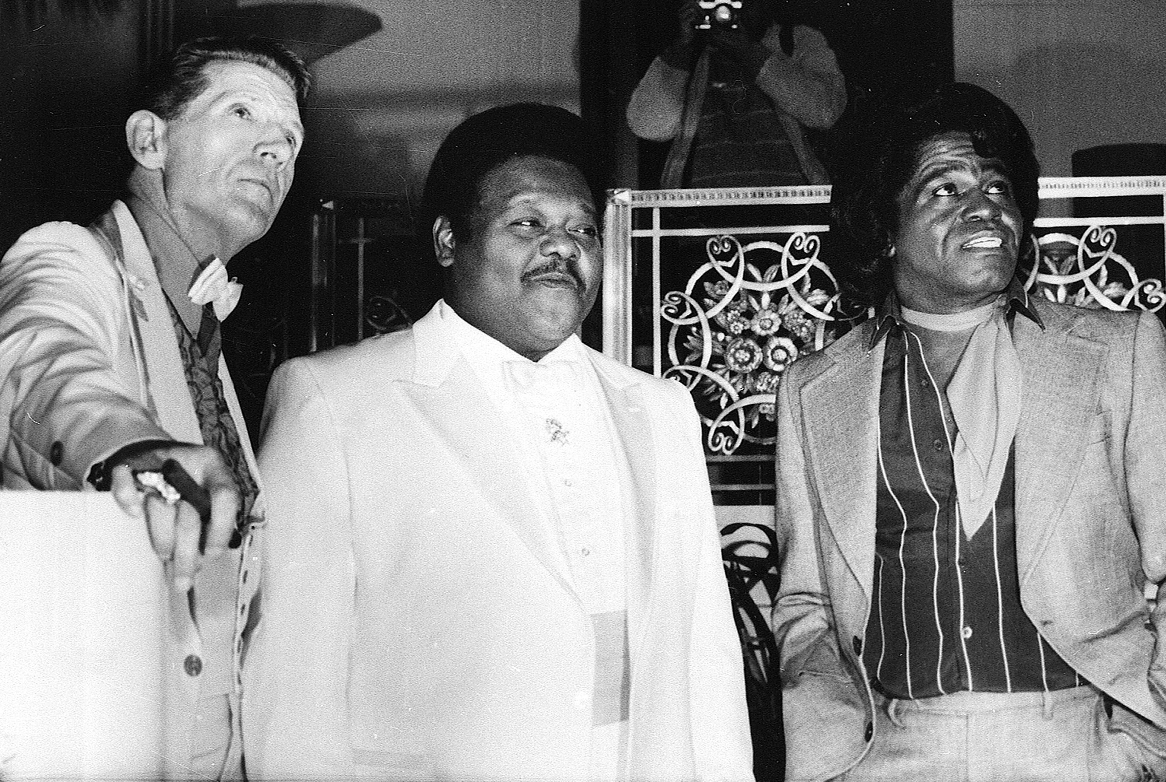 Rock and Roll musician Jerry Lee Lewis and Rhythm and Blues musicians Fats Domino and James Brown pose at a reception where they were inducted into the Rock and Roll Hall of Fame at the Waldorf-Astoria Hotel in New York City on Thursday, Jan. 23, 1986. (AP Photo/G. Paul Burnett)