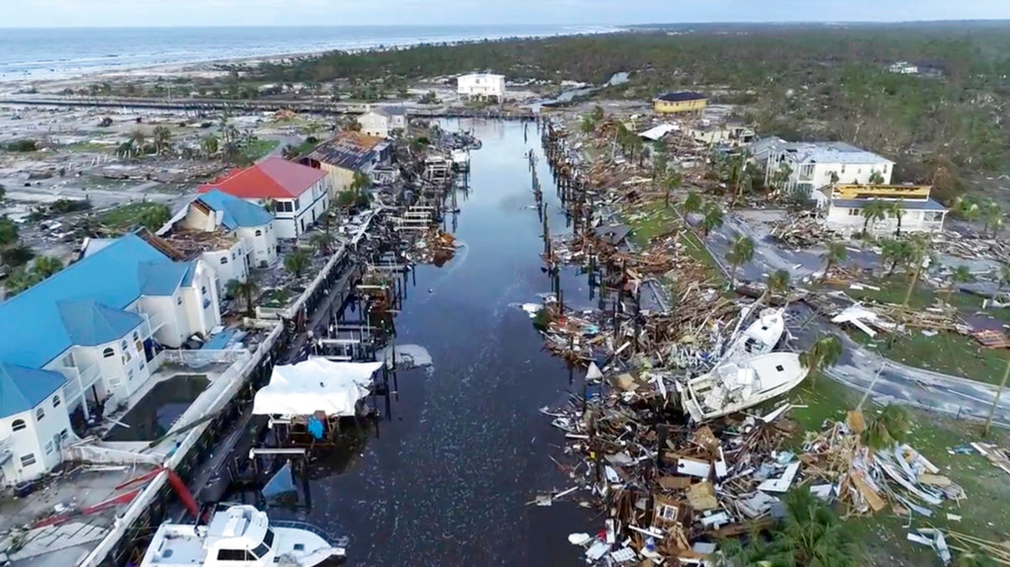 In this image made from video and provided by SevereStudios.com, damage from Hurricane Michael is seen in Mexico Beach, Fla. on Thursday, Oct. 11, 2018. Search-and-rescue teams fanned out across the Florida Panhandle to reach trapped people in Michael's wake Thursday as daylight yielded scenes of rows upon rows of houses smashed to pieces by the third-most powerful hurricane on record to hit the continental U.S. (SevereStudios.com via AP)