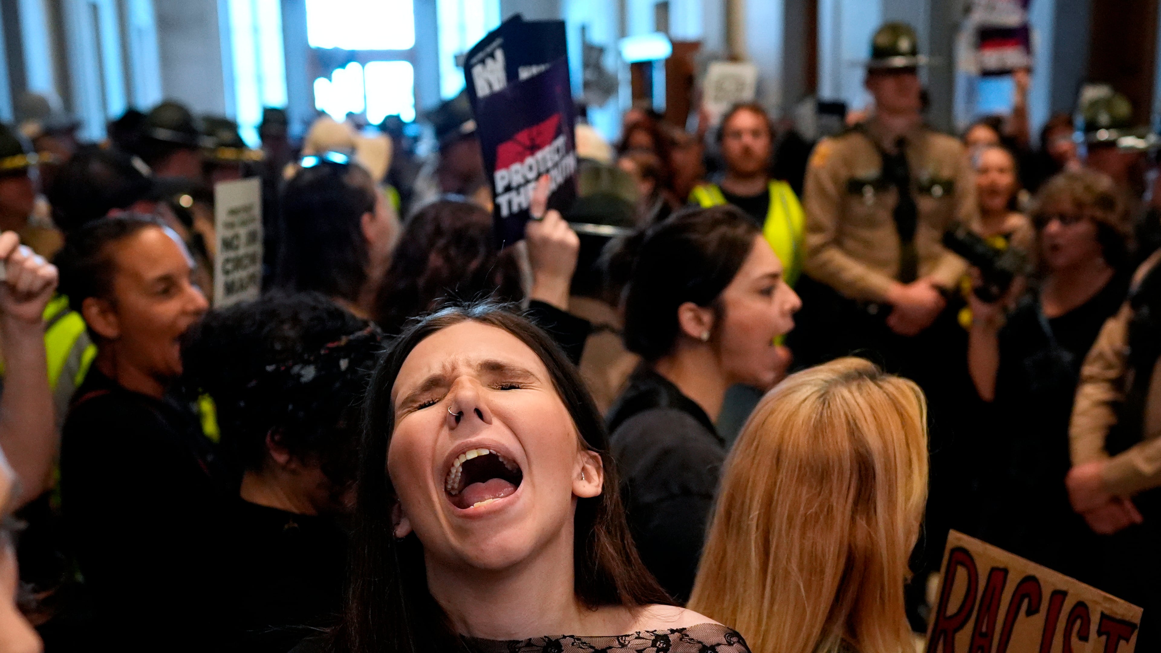 A woman protests outside the House chamber before a special session of the state legislature to redraw U.S. Congressional voting maps Thursday, May 7, 2026, in Nashville, Tenn. (AP Photo/George Walker IV)