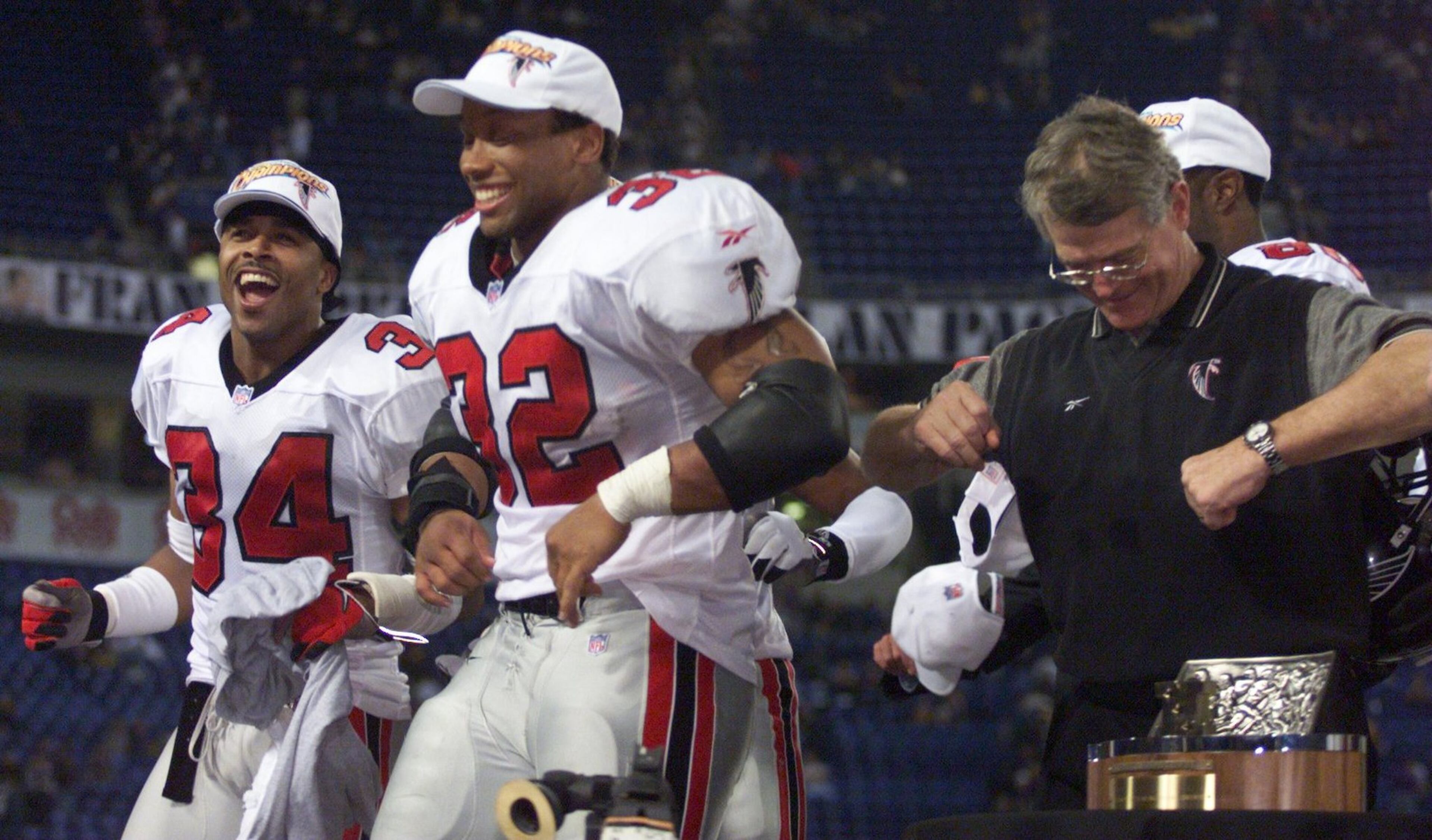 Jamal Anderson (center) does the Dirty Bird in 1998 alongside Falcons teammate Ray Buchanan (left) and head coach Dan Reeves.