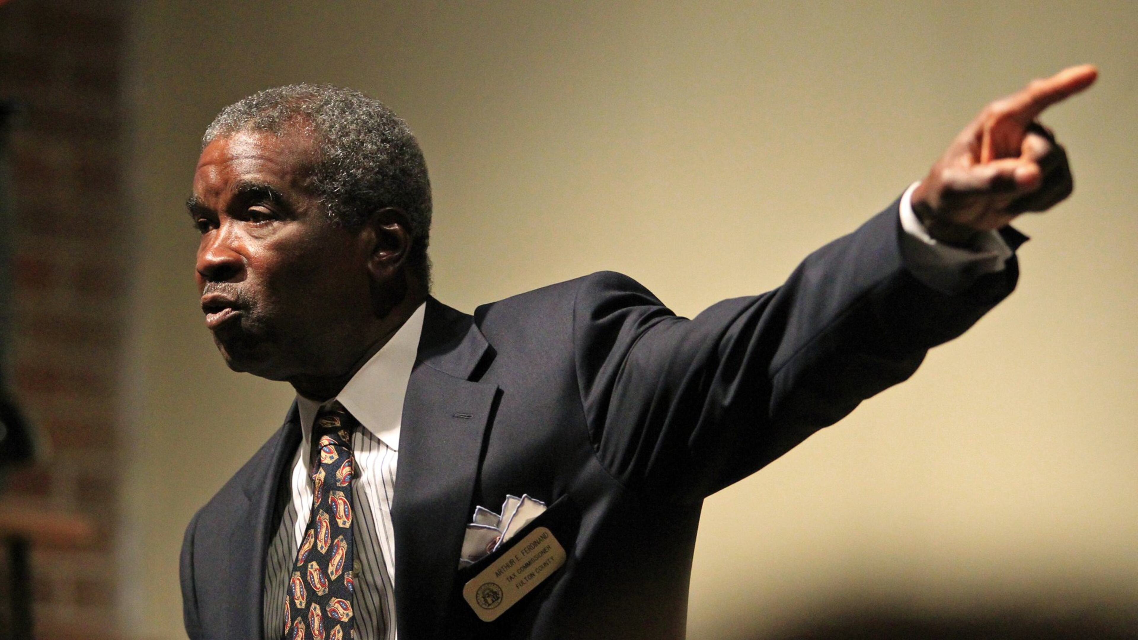 Longtime Fulton County Tax Commissioner Arthur Ferdinand talks during a candidate forum at the Fulton County Democratic Party in July 2012. Ferdinand has sparked outrage by pocketing personal fees for collecting three cities’ taxes, making him the state’s highest-paid elected official. JASON GETZ / JGETZ@AJC.COM