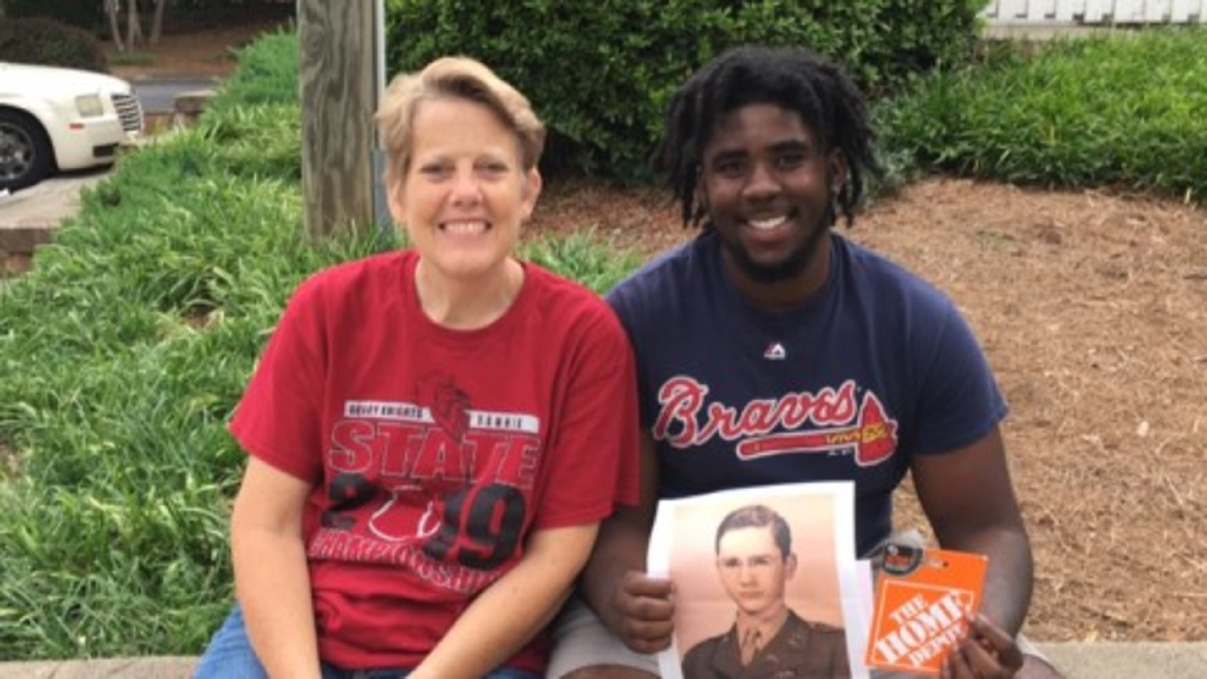 Grady High School principal Betsy Bockman is shown with 2019 graduate Dale Turnipseed, who is holding a photo of 1946 Tech High graduate Jim Logan. To honor Logan on his 91st birthday, his family wanted to give a donation to a current APS student. Bockman recommended Turnipseed.