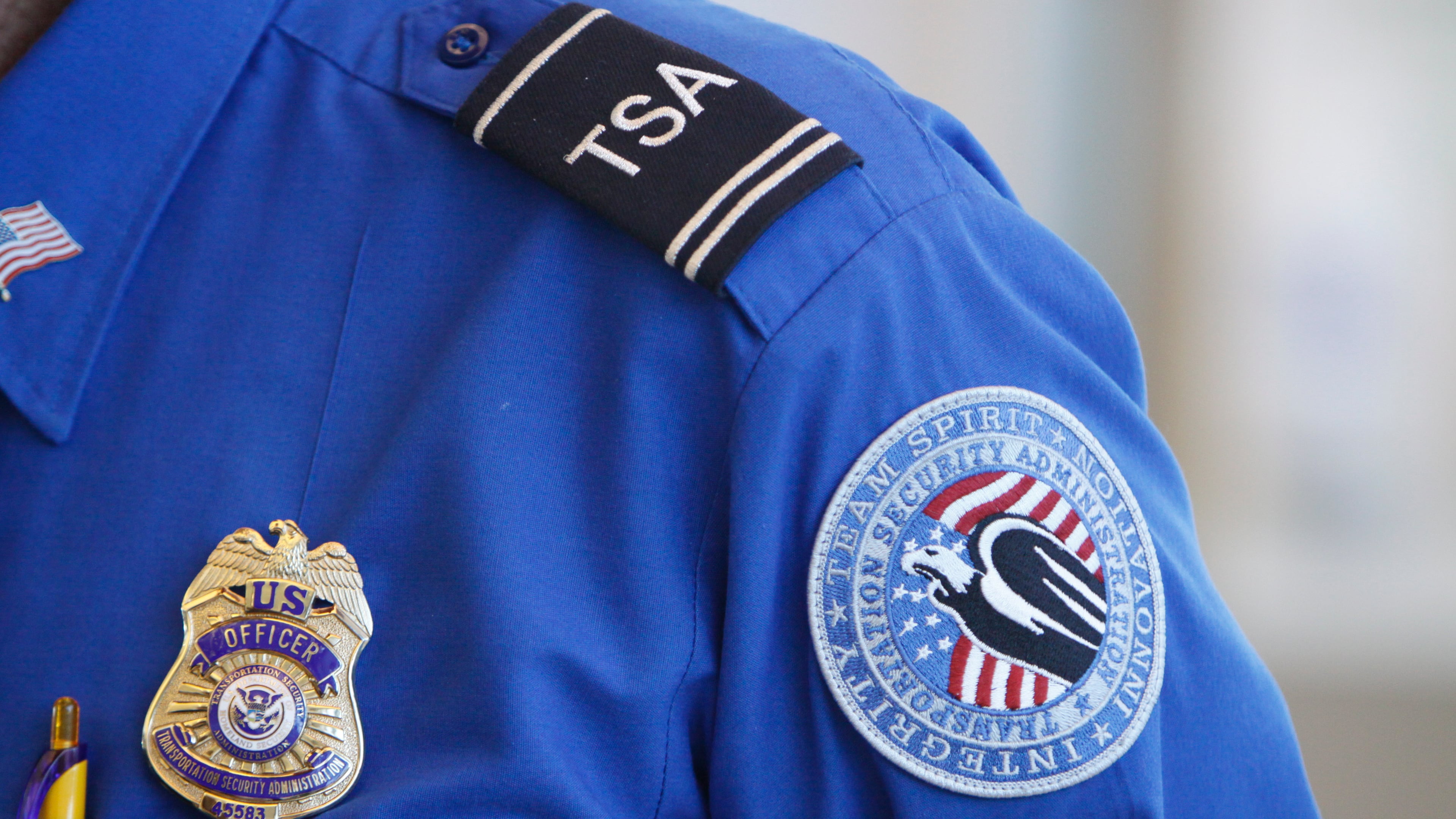 FILE -The badge and TSA logo patch are seen on the uniform of a Transportation Security Administration employee at one of the security checkpoints inside Lambert- St. Louis International Airport Oct. 7, 2010, in St. Louis. (AP Photo/Jeff Roberson, File)