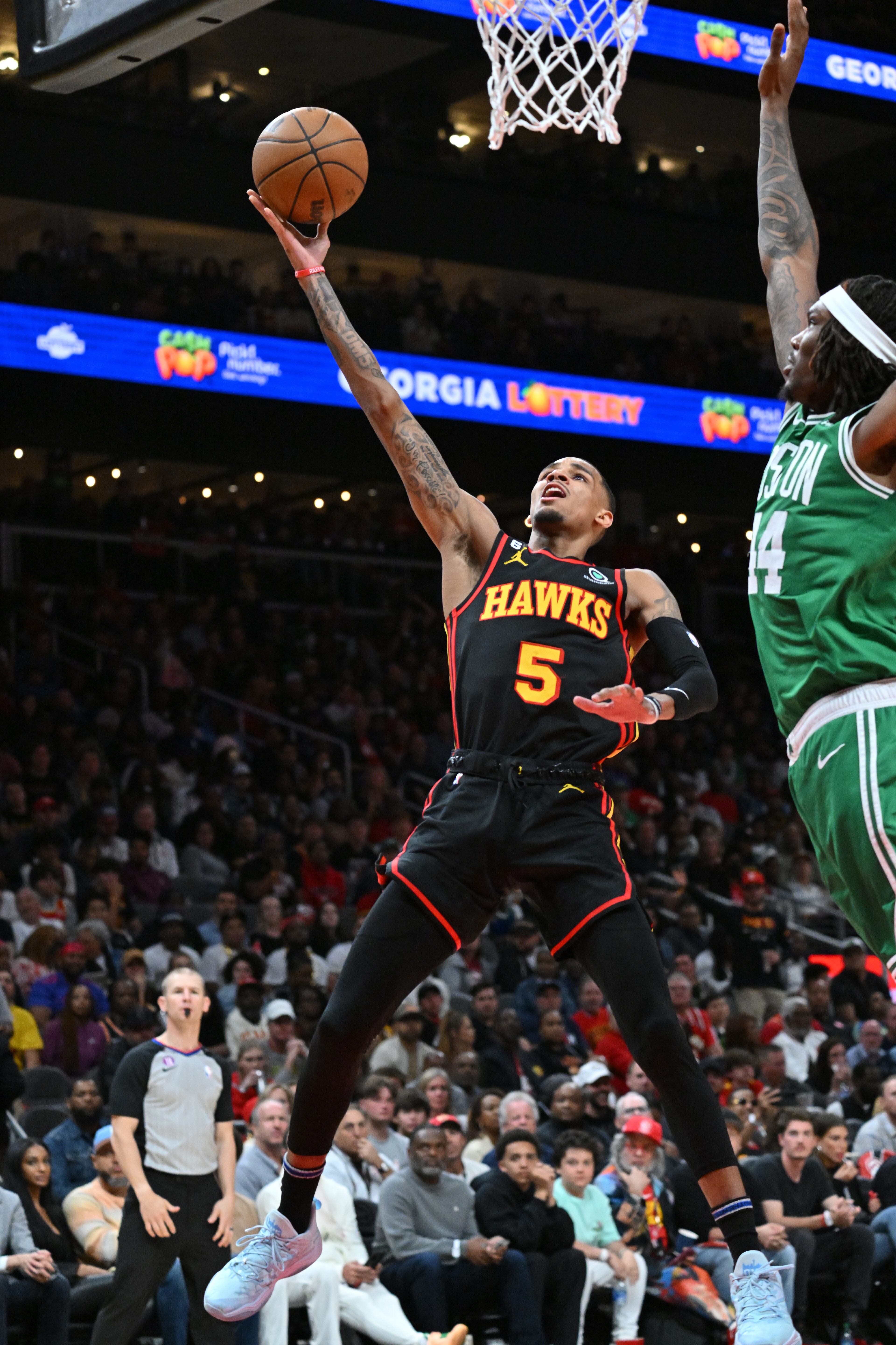 Hawks guard Dejounte Murray goes in for a layup against Celtics center Robert Williams III during the second half of Game 4 of the first round of the Eastern Conference playoffs at State Farm Arena, Sunday, April 23, 2023, in Atlanta. The Celtics won 129-121. (Hyosub Shin / Hyosub.Shin@ajc.com)