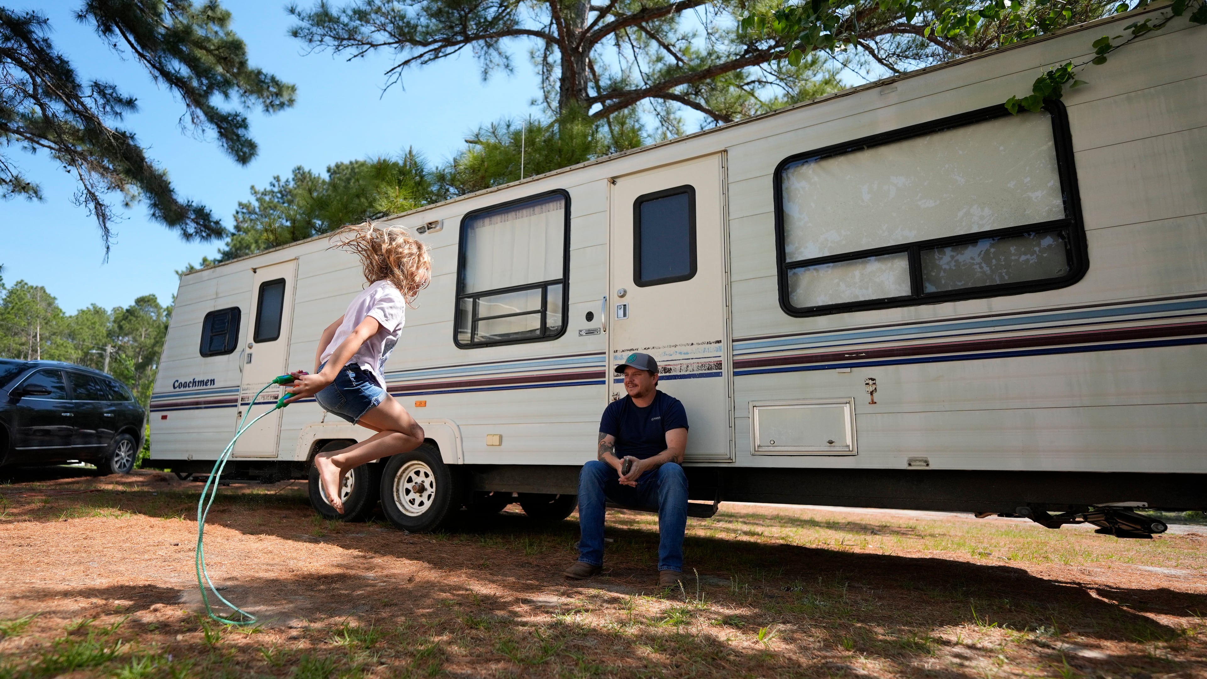 Annabelle Enke plays as her father Michael Gibson looks on after losing thier home at the Brantley Highway 82 fire, Friday, April 24, 2026, in Nahunta, Ga. (Mike Stewart/AP)