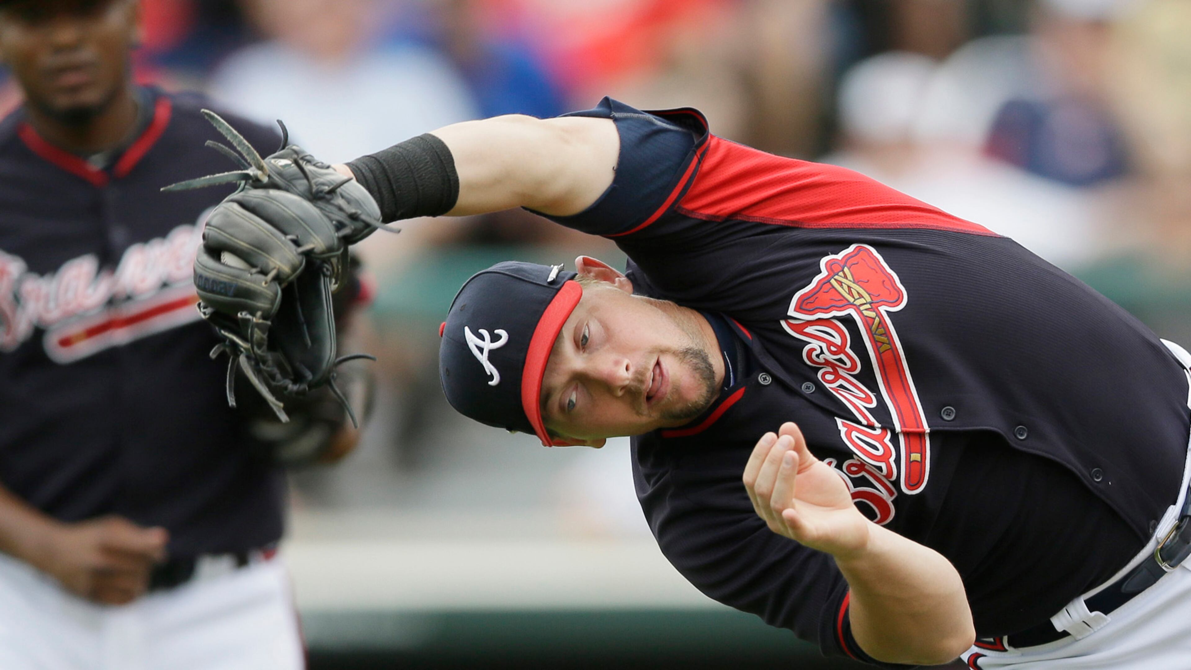 Atlanta Braves third baseman Chris Johnson catches the popup hit by Boston Red Sox's Dustin Pedroia during the fourth inning of a spring training exhibition baseball game in Kissimmee, Fla., Friday, March 27, 2015. (AP Photo/Carlos Osorio)