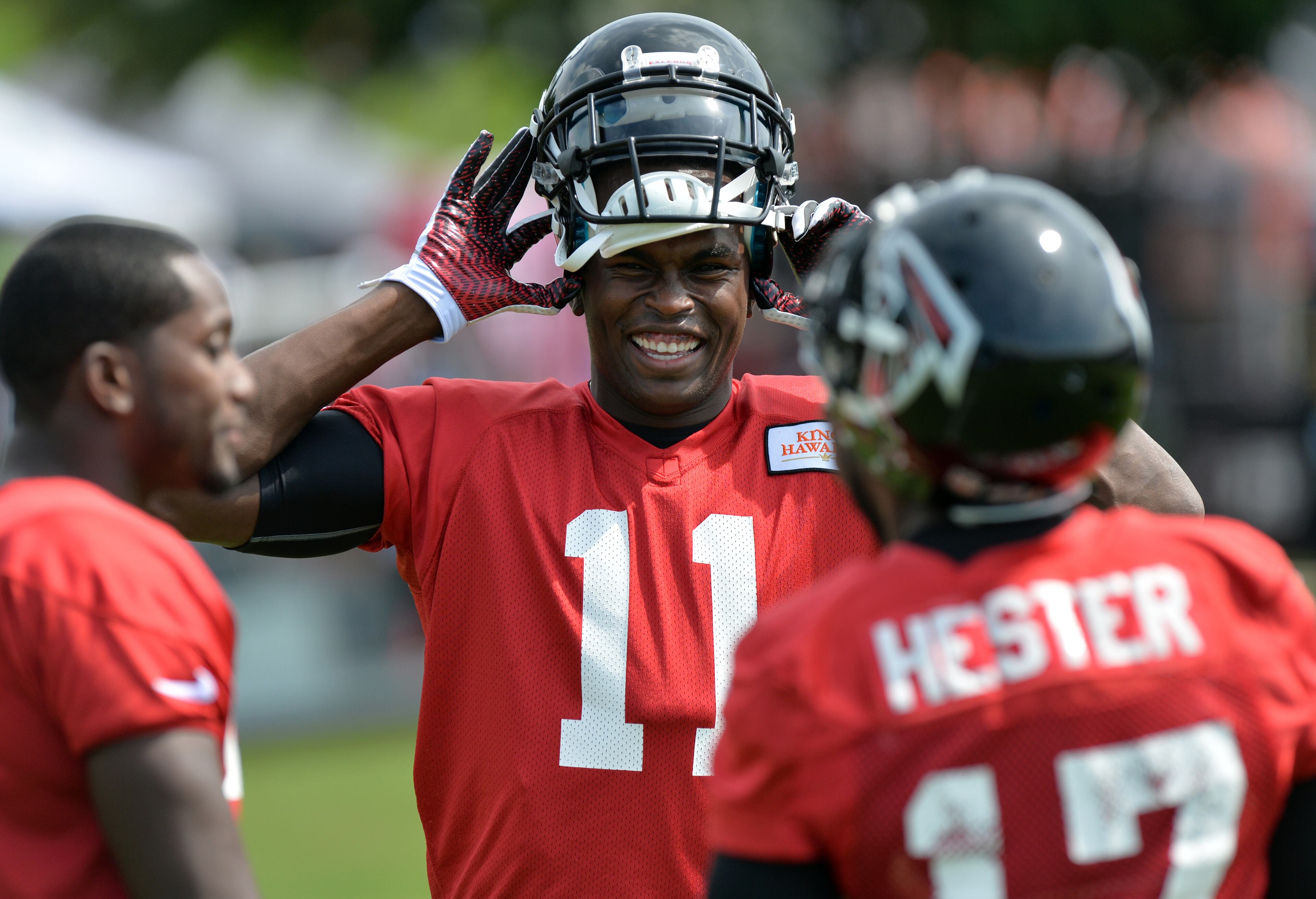 Atlanta Falcons wide receiver Julio Jones (11) jokes with teammates during training camp on Friday, July 25, 2014.