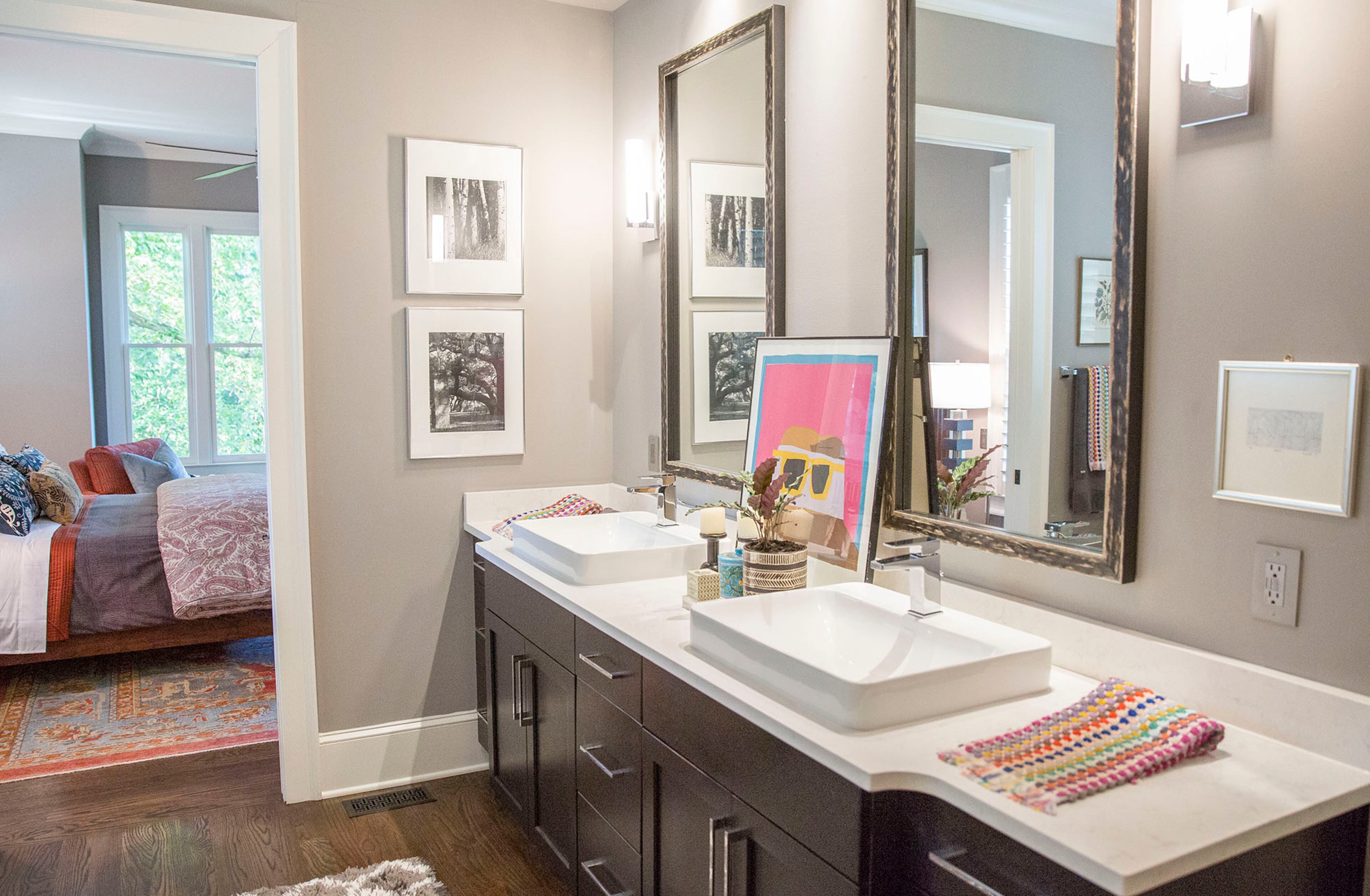 Bold artwork, global patterns and the homeowner's black-and-white photography add personal touches to the master bathroom.
