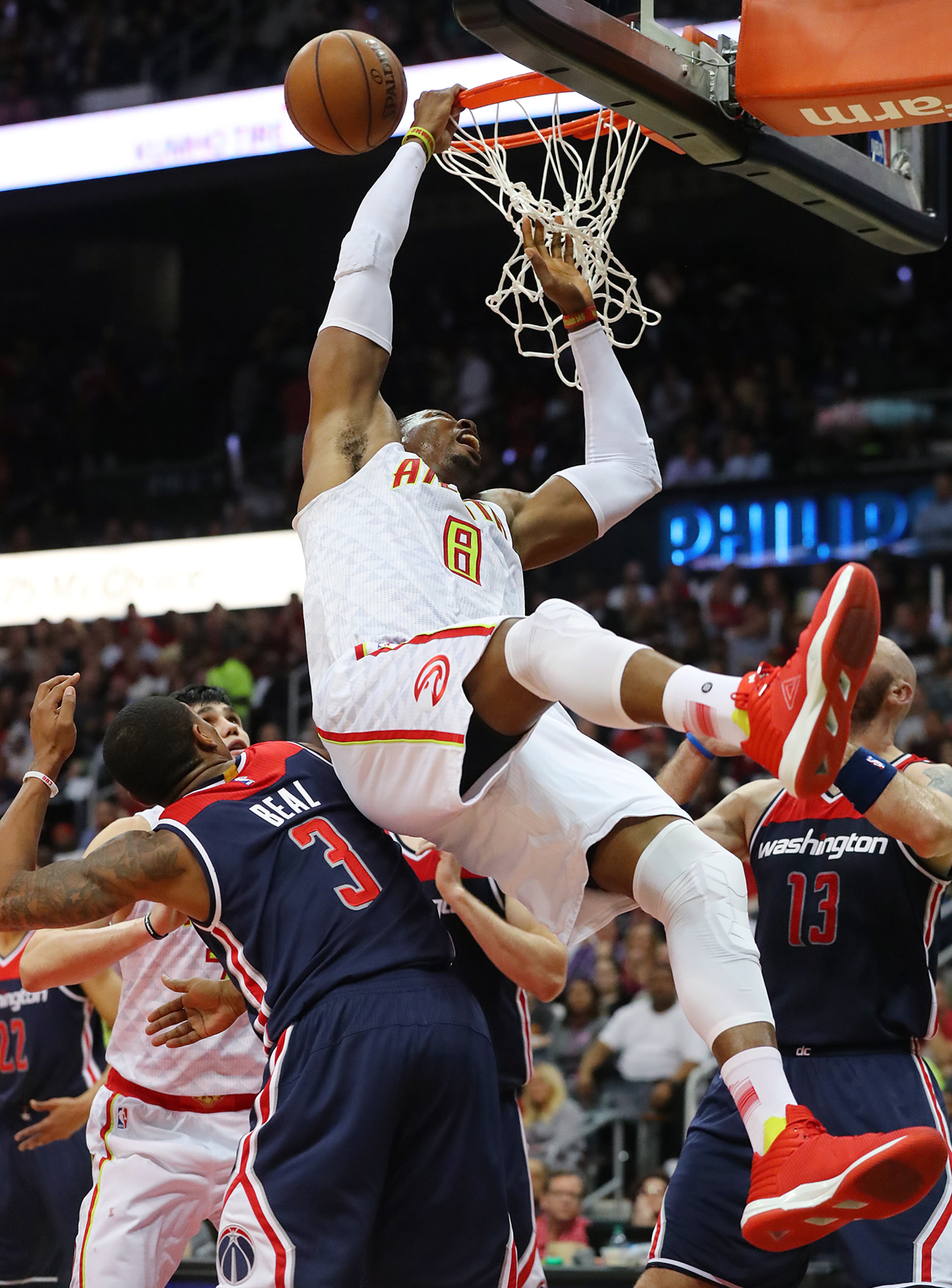 Dwight Howard collides with Bradley Beal going to the basket to slam in game 4 of a first-round NBA basketball playoff series on Monday, April 24, 2017, in Atlanta.