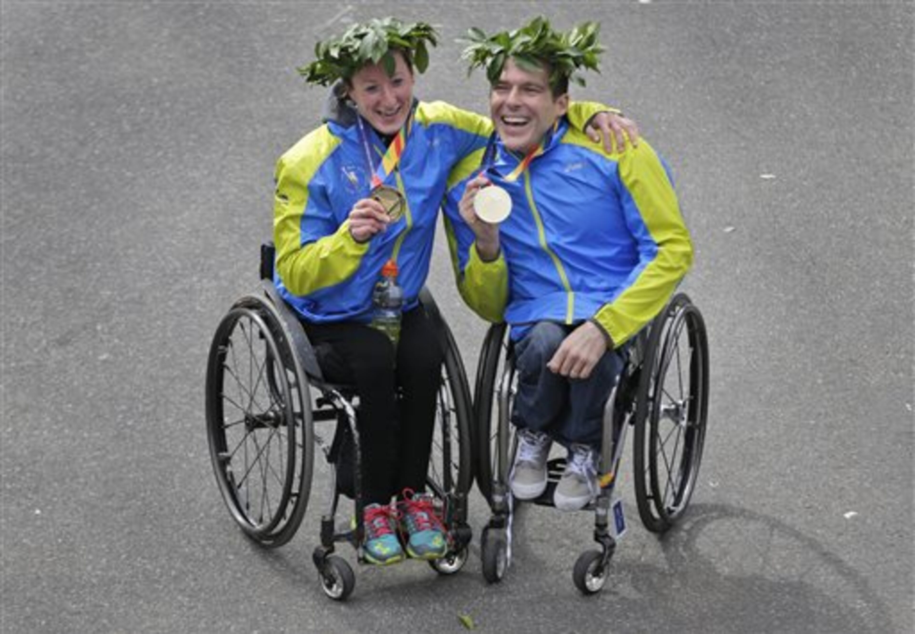 Kurt Fearnely of Australia and Tatyana McFadden of the United States, first place finishers in the wheeler divisions, pose for a picture at the 2014 New York City Marathon in New York, Sunday, Nov. 2, 2014. (AP Photo/Seth Wenig)