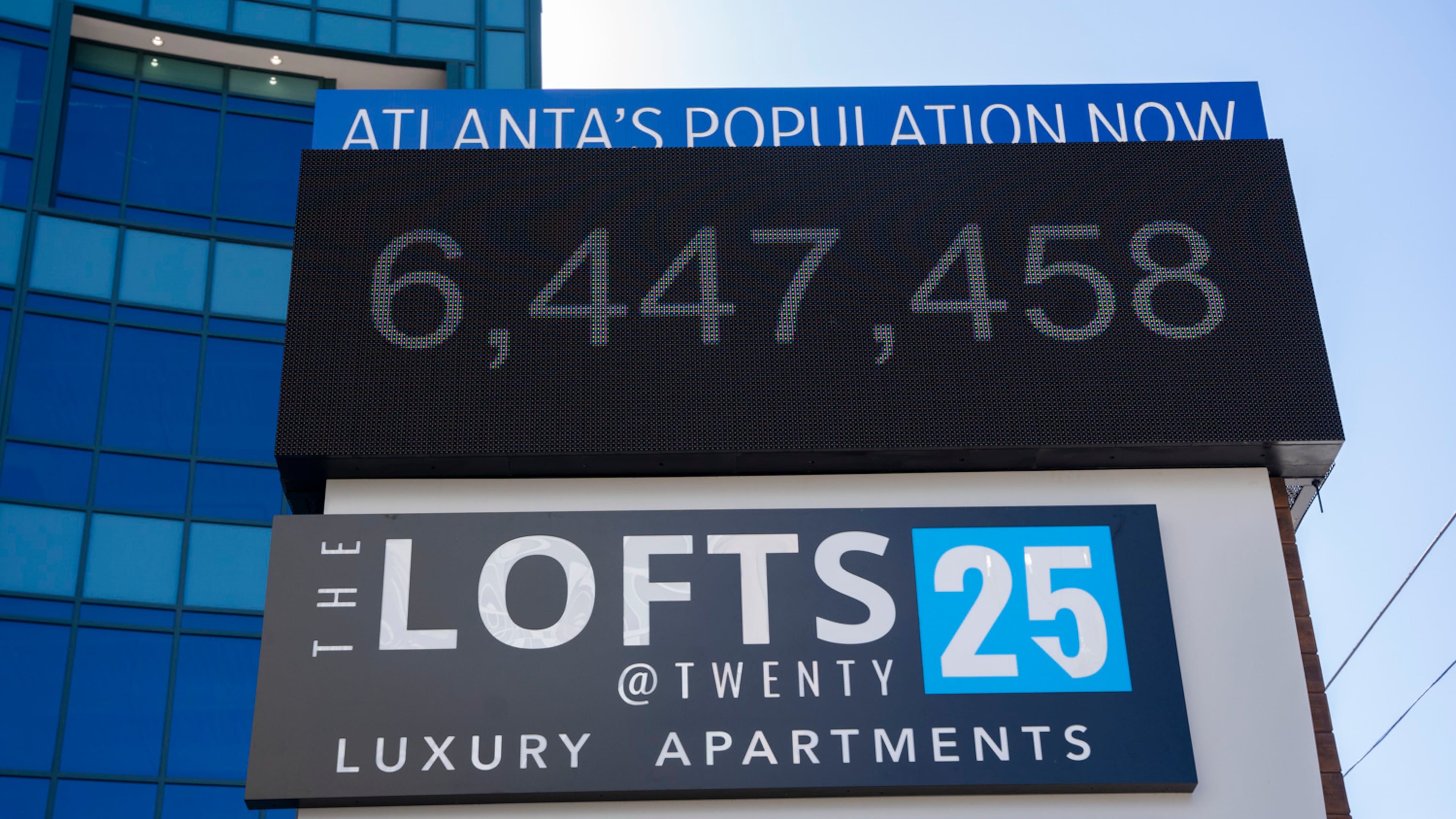 A sign outside the the Lofts at Twenty25 apartment complex displays the current population of Atlanta on Wednesday, Feb. 14, 2024. (Olivia Bowdoin for the AJC).