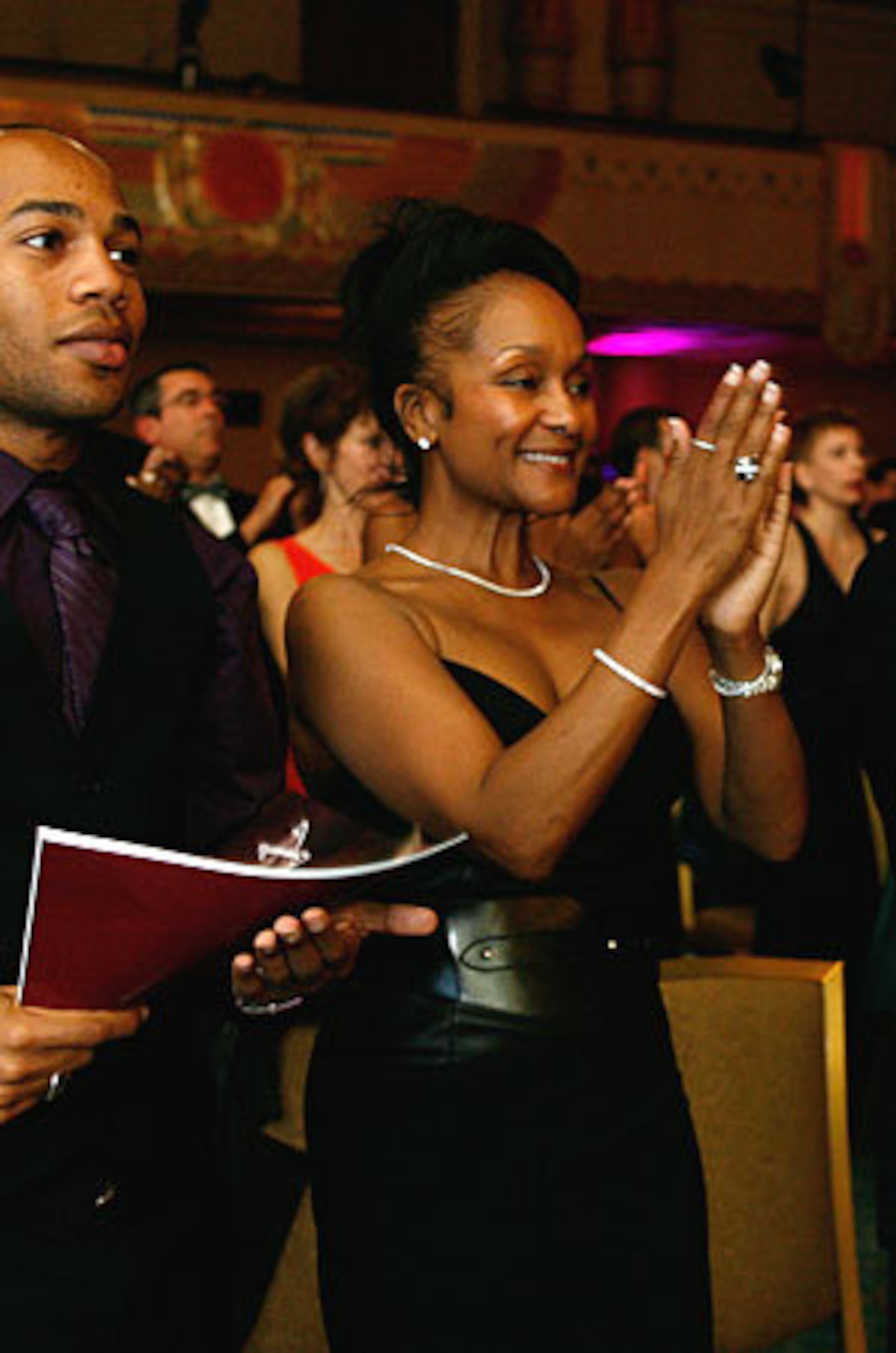 Jen Harper applauds Pearl Cleage as she takes the stage for her award in the Suzi Bass Awards.