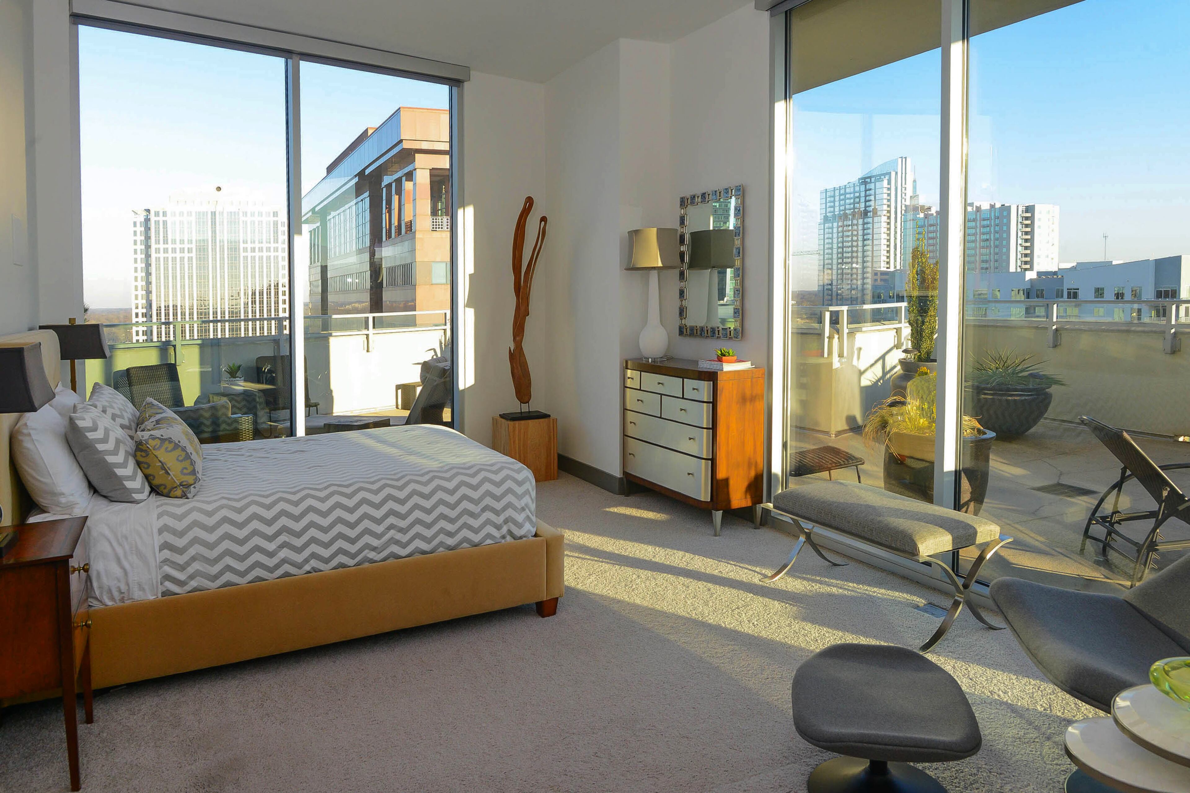 The modern city vibe continues in the guest bedroom, which has a platform-style bed from Mitchell Gold + Bob Williams and a dresser from Caracole.