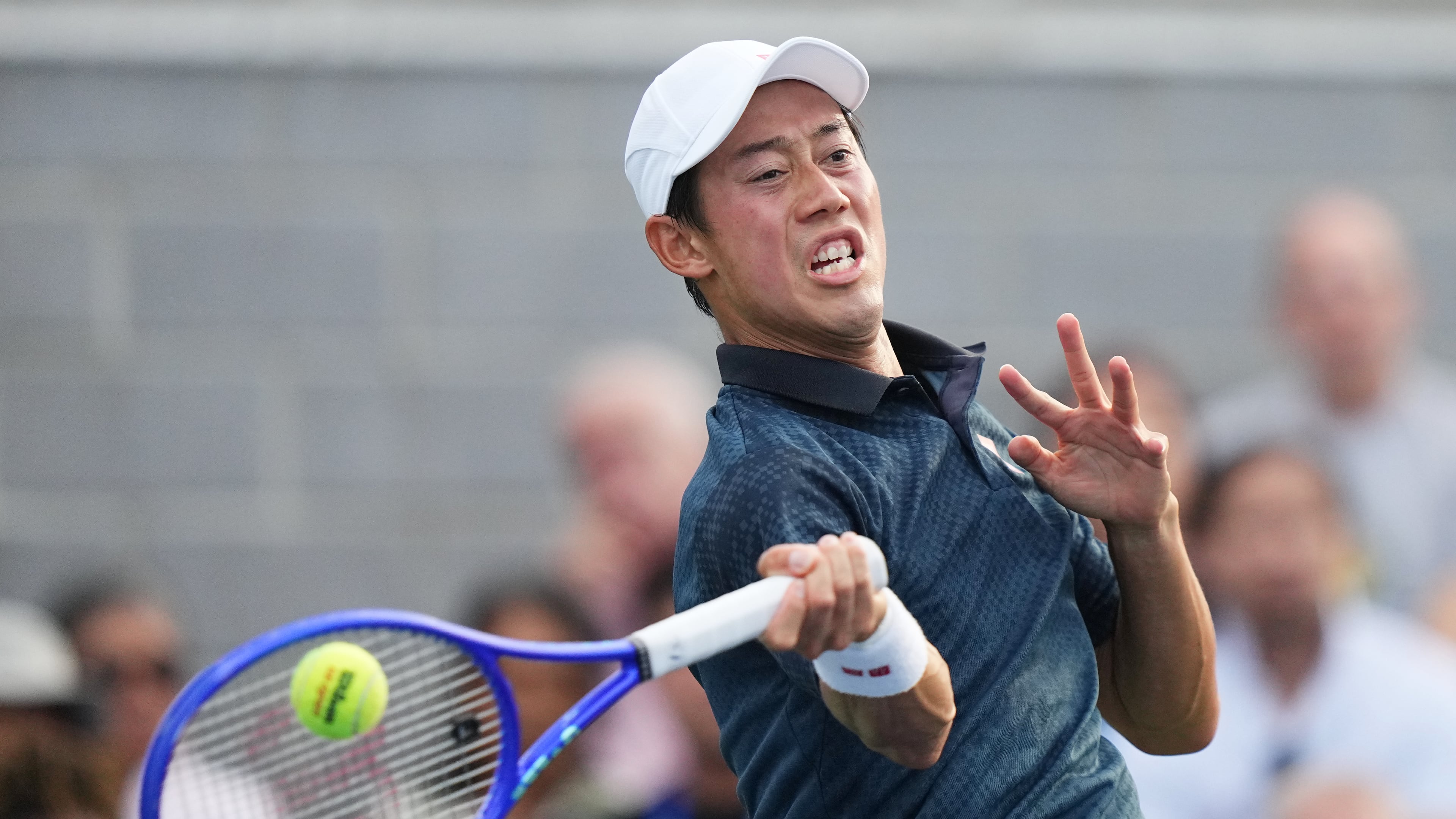 Kei Nishikori, of Japan, returns the ball to Michael Antonius, of the United States, during a qualifying match at the U.S. Open tennis championships Wednesday, Aug. 26, 2026, in New York. (AP Photo/Frank Franklin II)