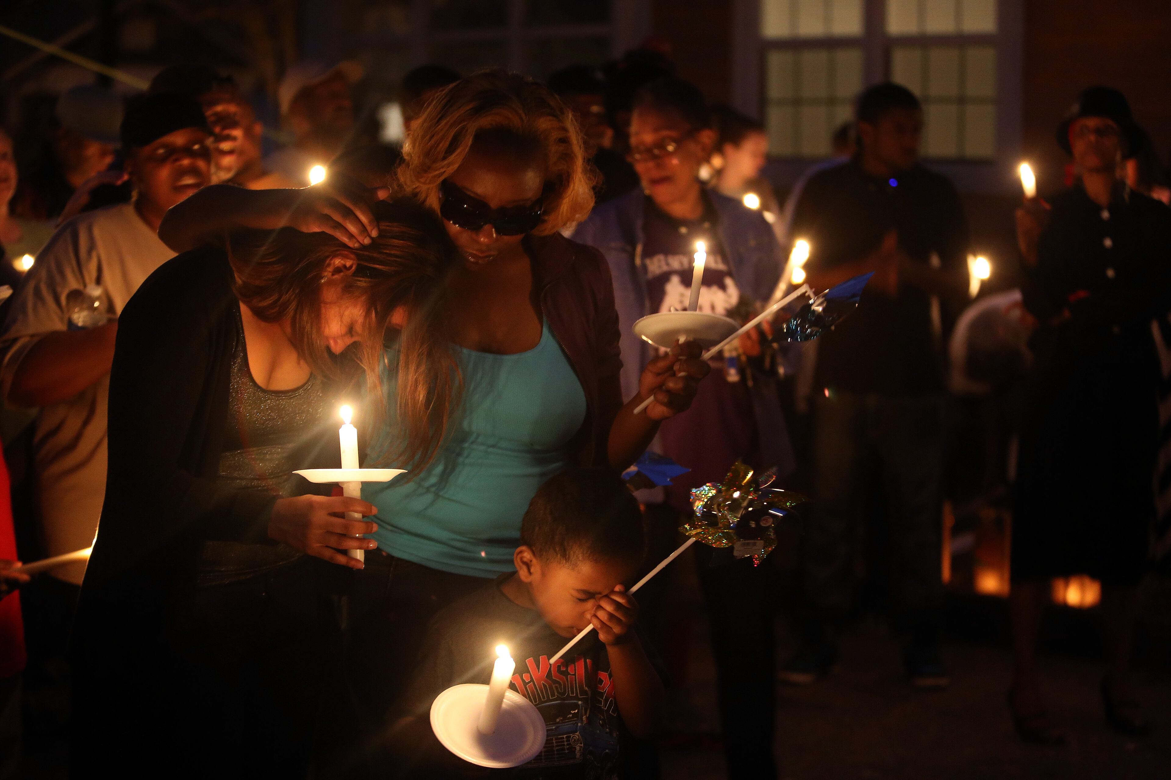 Family, friends and neighbors mourn during a vigil for Kelcey "Skeet" Thornton on Tuesday evening March 11, 2014 at the spot in the Peoplestown neighborhood of Atlanta where he was shot and killed Sunday evening.