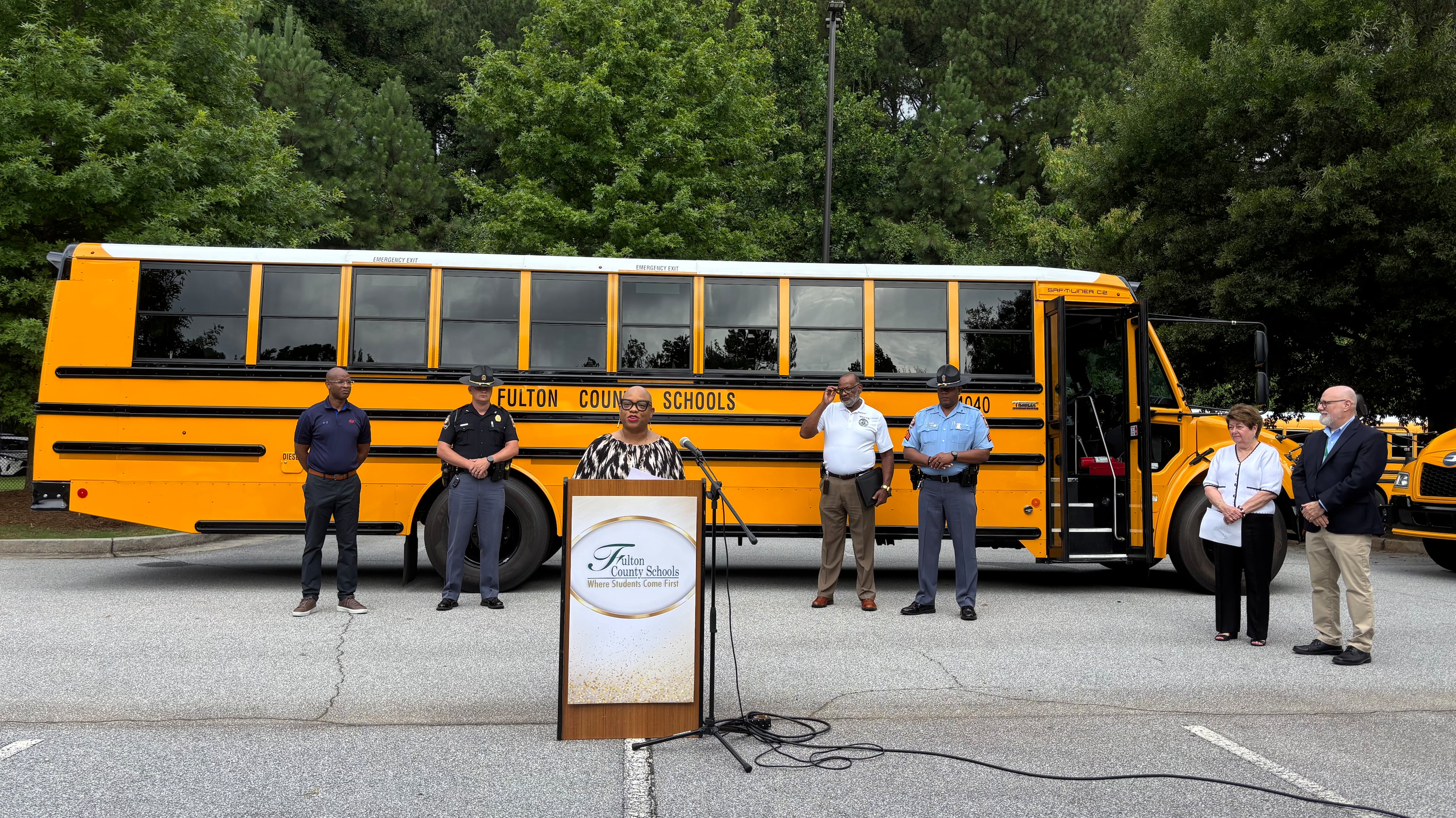 Officials from AAA, the Governor's Office of Highway Safety, Fulton County Schools and the Georgia State Patrol warn drivers around buses to slow down, stop around buses and keep their eyes on the road at Heards Ferry Elementary School in Sandy Springs on Thursday, Aug. 1, 2025. (Doug Turnbull for the AJC)