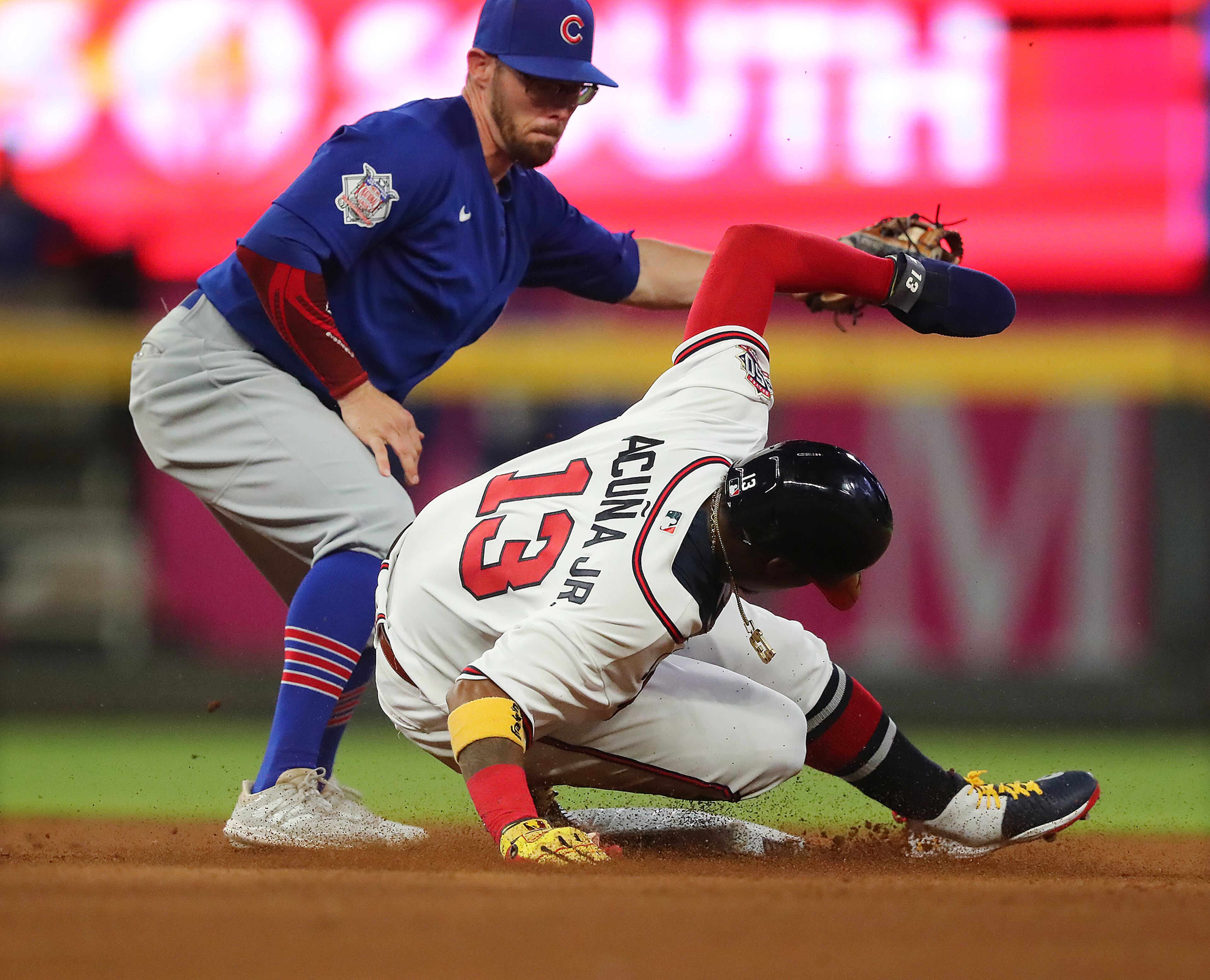 Braves outfielder Ronald Acuna slides into second safely, advancing on a sacrifice fly by Freddie Freeman - during the fourth inning Monday, April 26, 2021, against the Chicago Cubs at Truist Park in Atlanta. (Curtis Compton / Curtis.Compton@ajc.com)