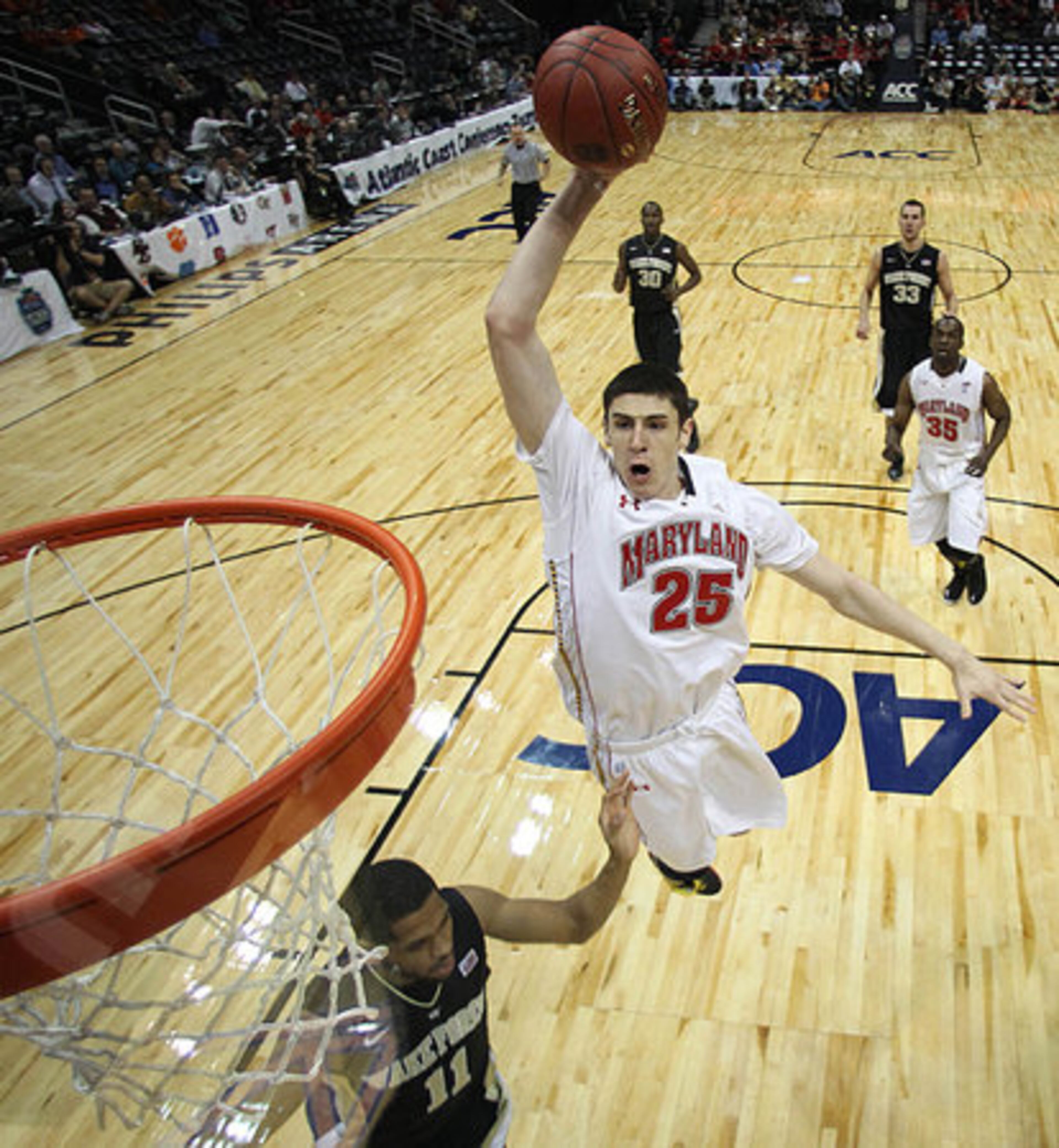 Maryland center Alex Len (25) heads to the basket as Wake Forest guard C.J. Harris (11) looks on in the first half of an NCAA college basketball first round game at the Atlantic Coast Conference tournament, Thursday, March 8, 2012, in Atlanta.