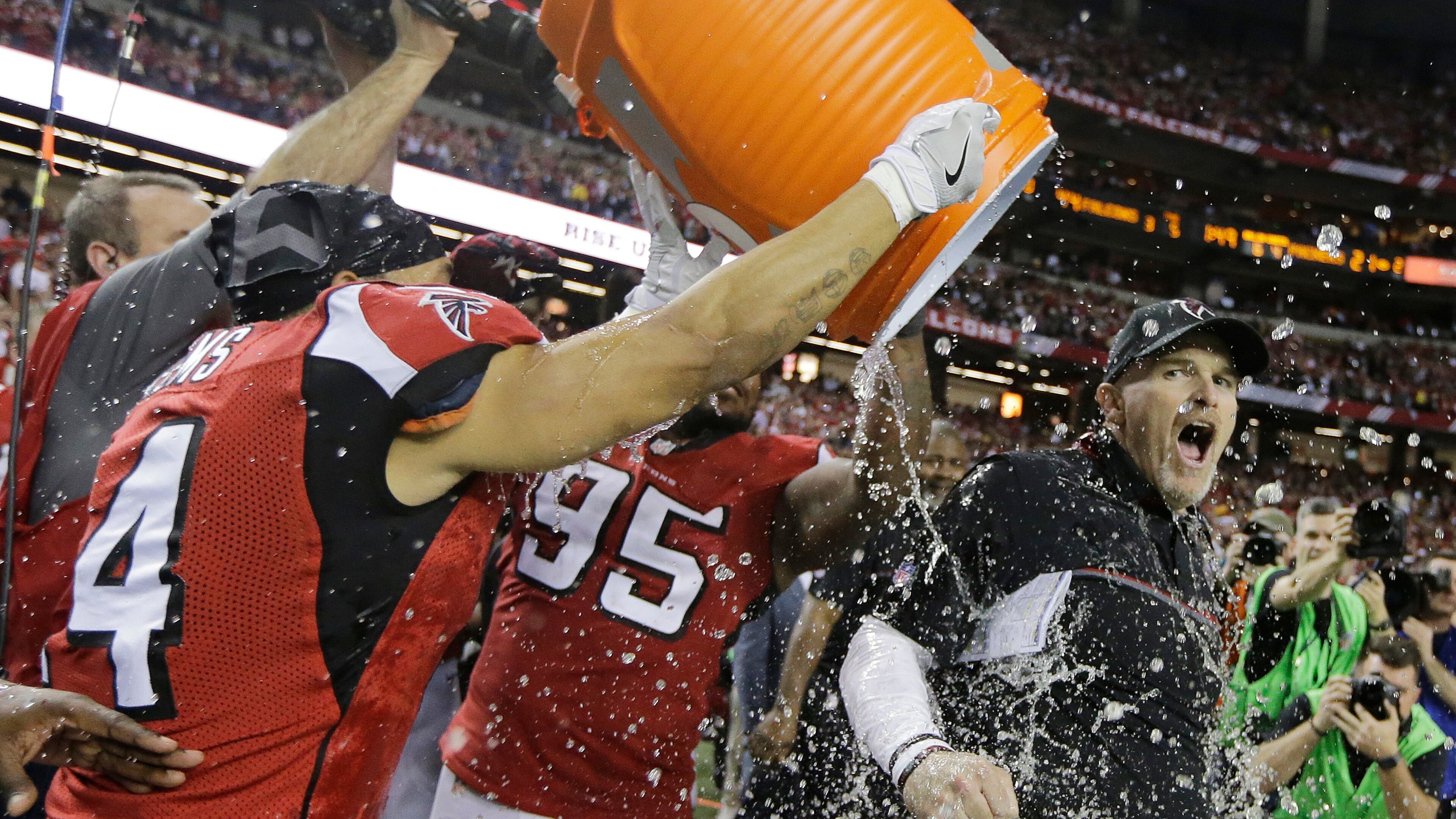 Atlanta Falcons head coach Dan Quinn reacts as he is dunked after the NFL football NFC championship game against the Green Bay Packers Sunday, Jan. 22, 2017, in Atlanta. The Falcons won 44-21 to advance to Super Bowl LI. (AP Photo/Mark Humphrey)