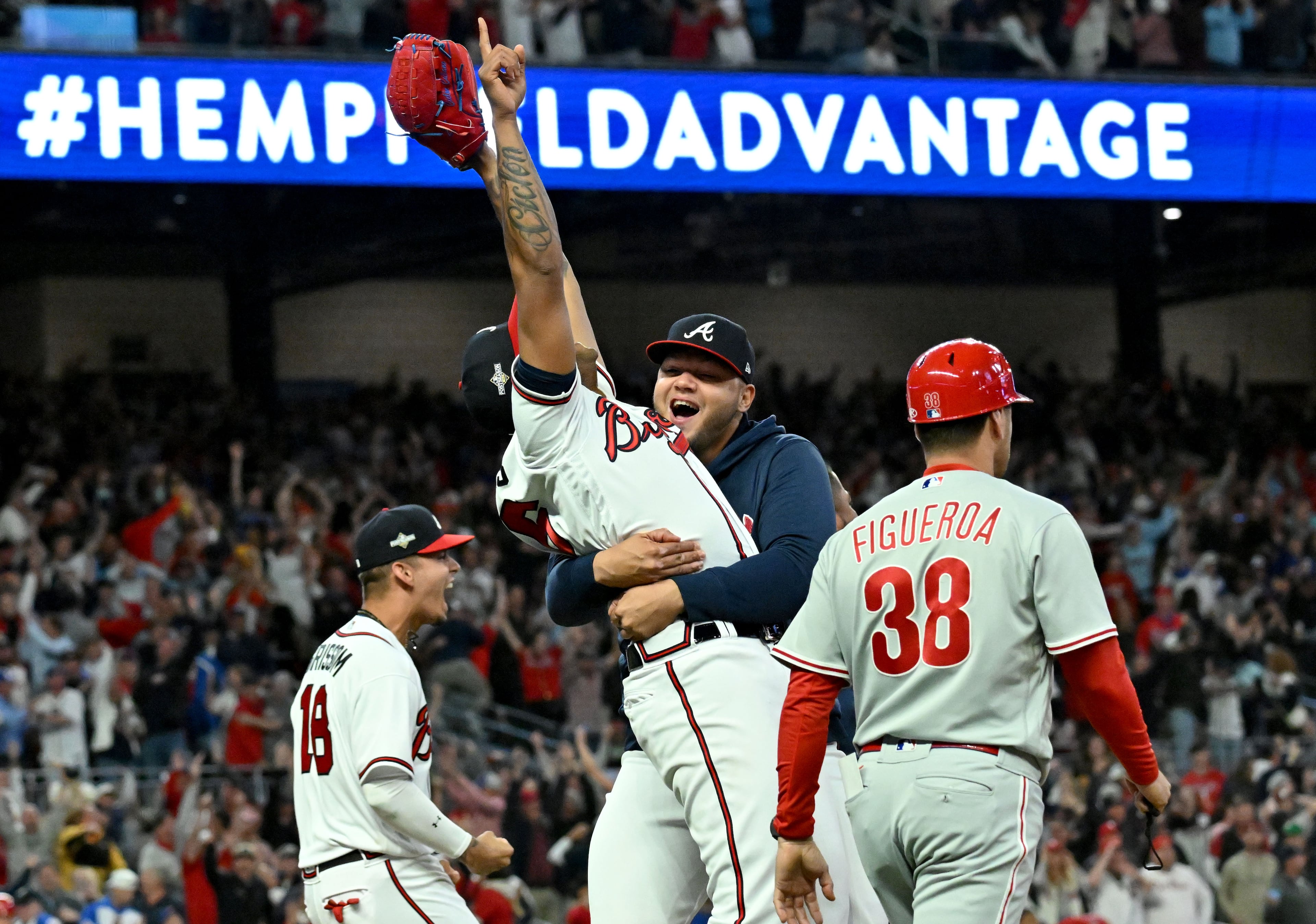 Atlanta Braves relief pitcher Raisel Iglesias (26) is congratulated by teammates after the win. (Hyosub Shin / Hyosub.Shin@ajc.com)