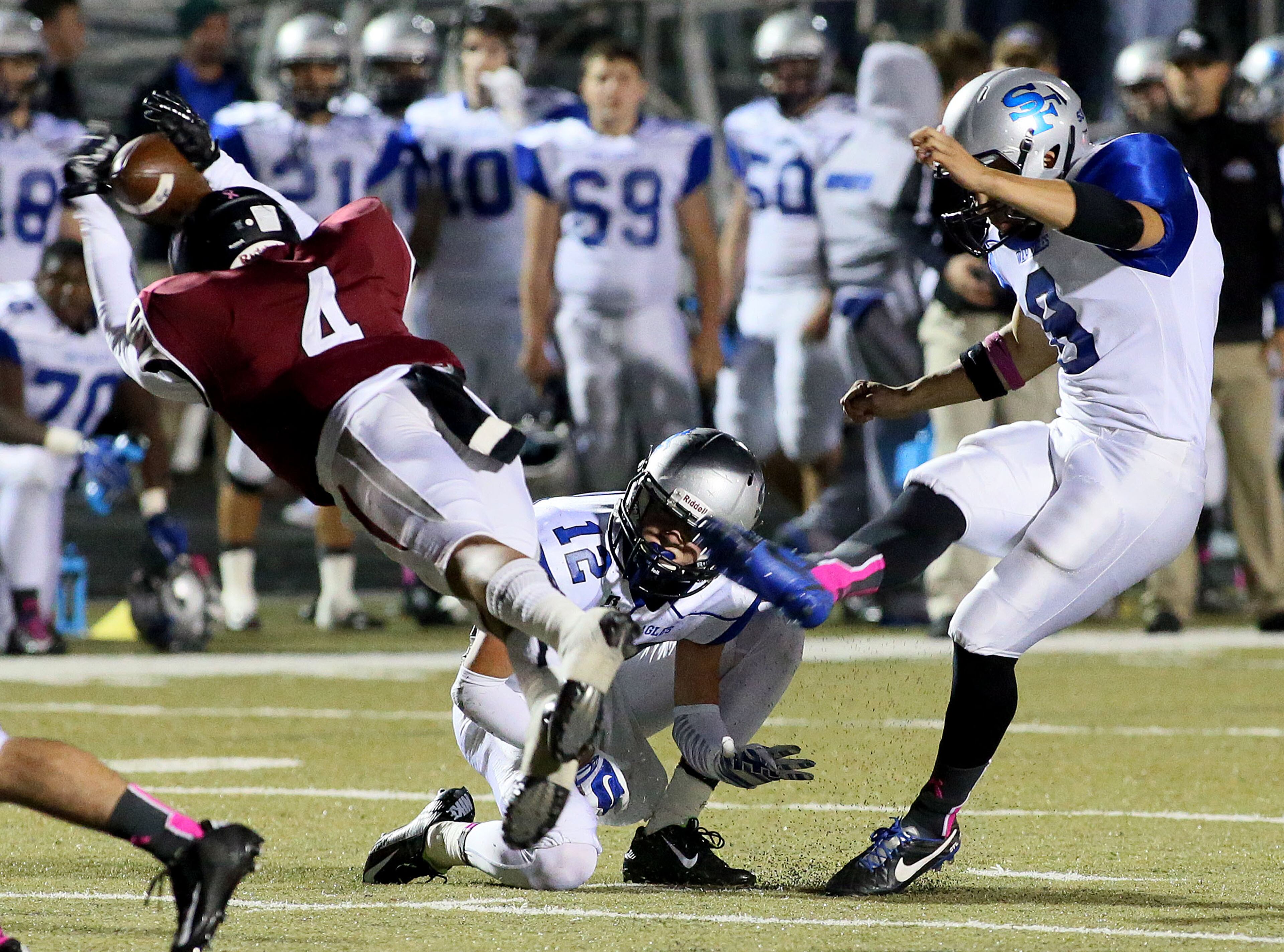 Alpharetta's #4 Devin Mayers blocks a field goal attempt by South Forsyth's kicker #8 Alex Barbir in first half game action at Raider Stadium in Alpharetta on Friday, October 24, 2014. (Photo by Phil Skinner)